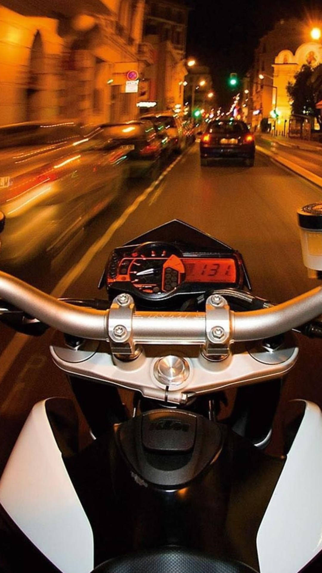 城市 桌布 壁紙 — 從機車以第一人稱視角在夜間高速駛過溫暖燈光的城市街道，帶有模糊動態效果。