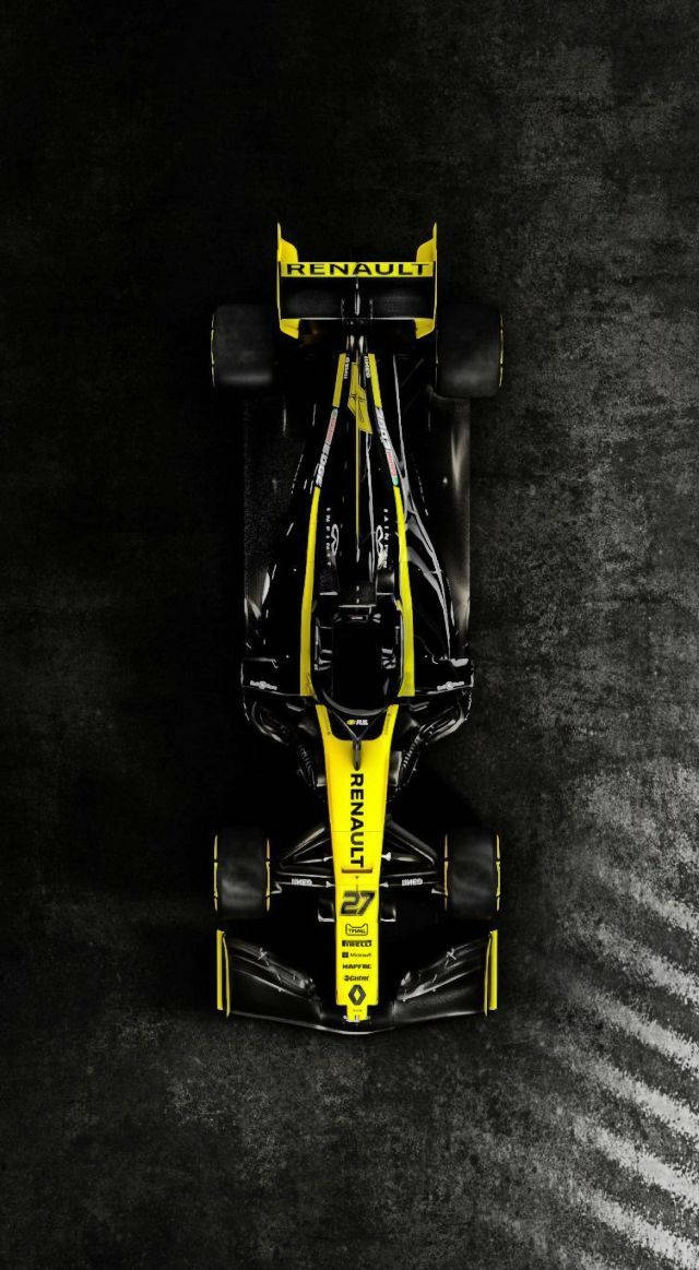 F1 桌布 壁紙 — 從正上方俯瞰一輛黑色和黃色的雷諾一級方程式賽車在深色紋理賽道表面上的景象。