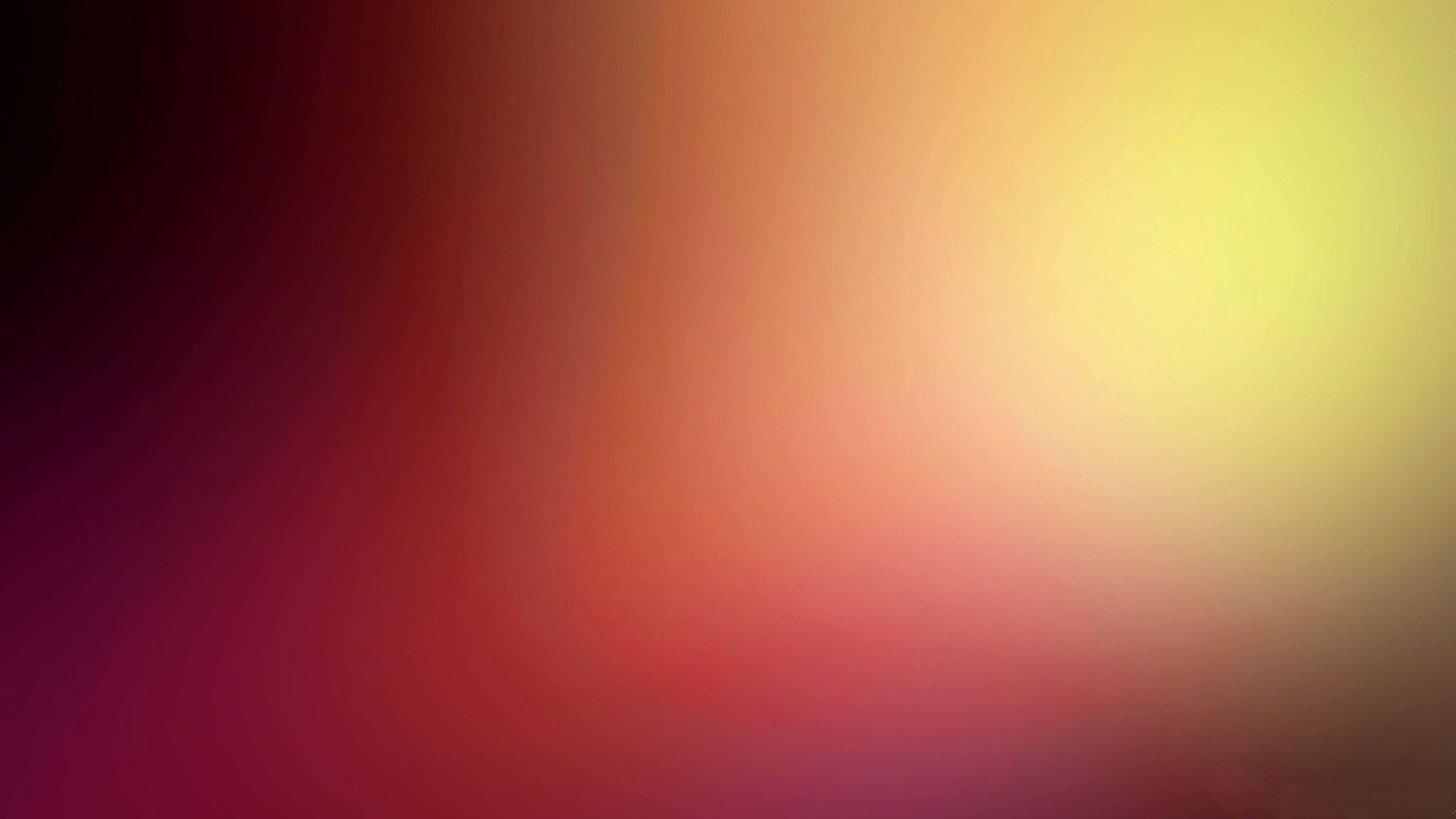 Gradient 桌布 壁紙 — 從深洋紅色到暖黃色的平滑漸變，營造出柔和發光的抽象背景。