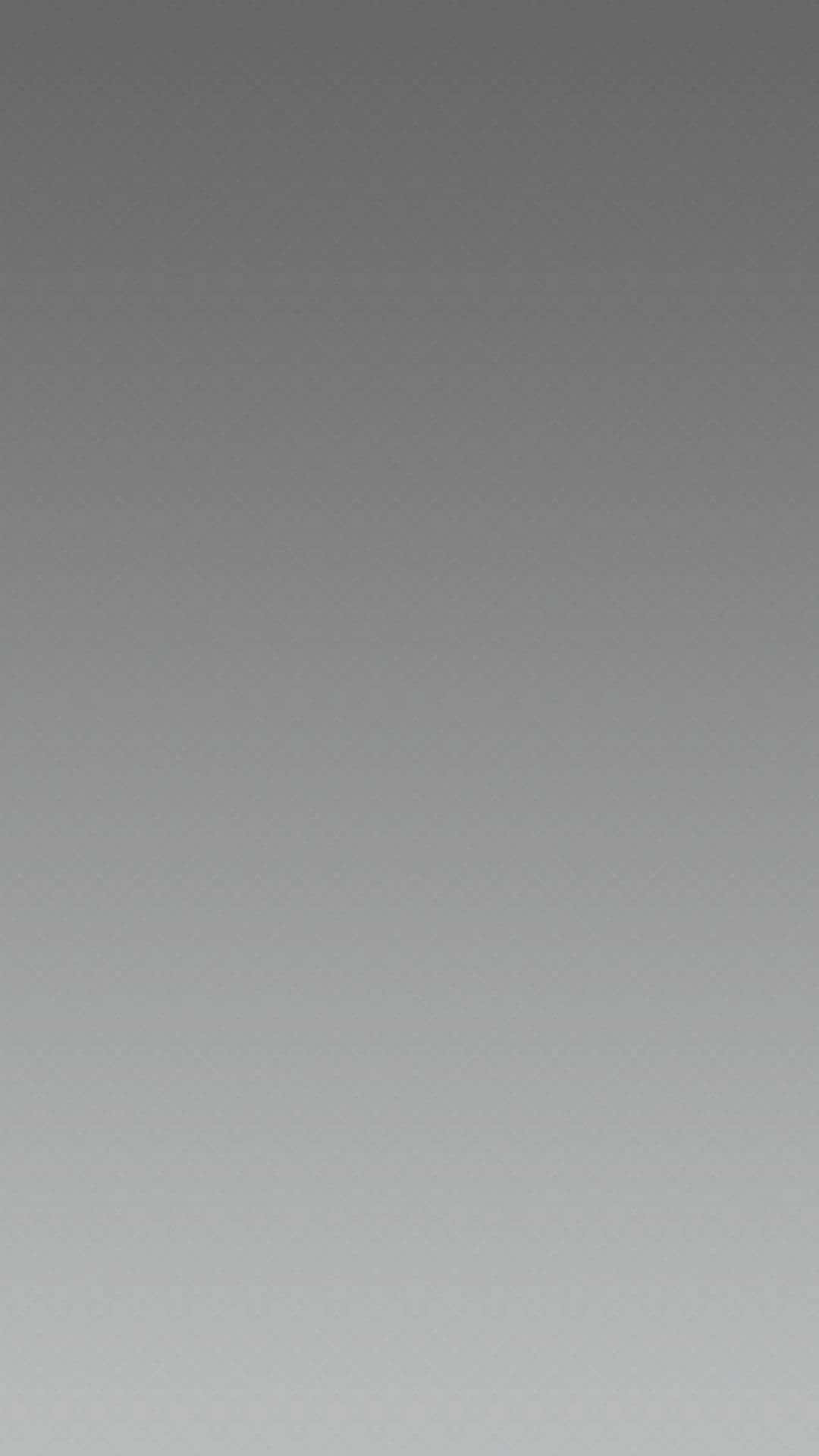 Gray Gradient 桌布 壁紙 — 從深灰色過渡到淺灰色的極簡漸變桌布，帶有細微紋理。