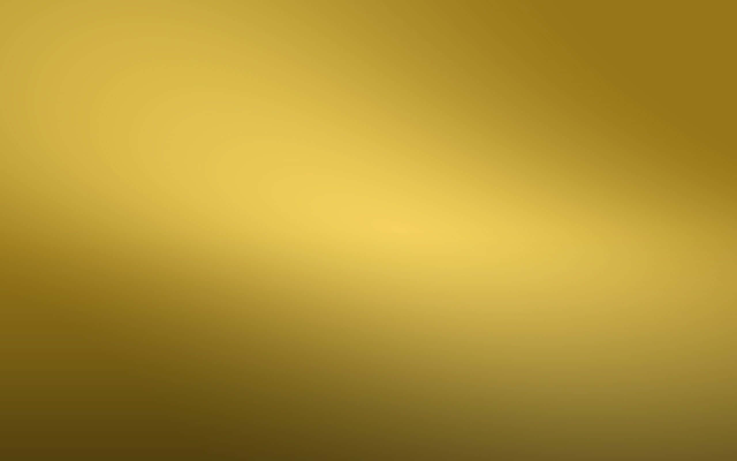 Yellow Gradient 桌布 壁紙 — 從深琥珀色到柔和黃色，整個畫面呈現溫暖金色色調的平滑漸變。