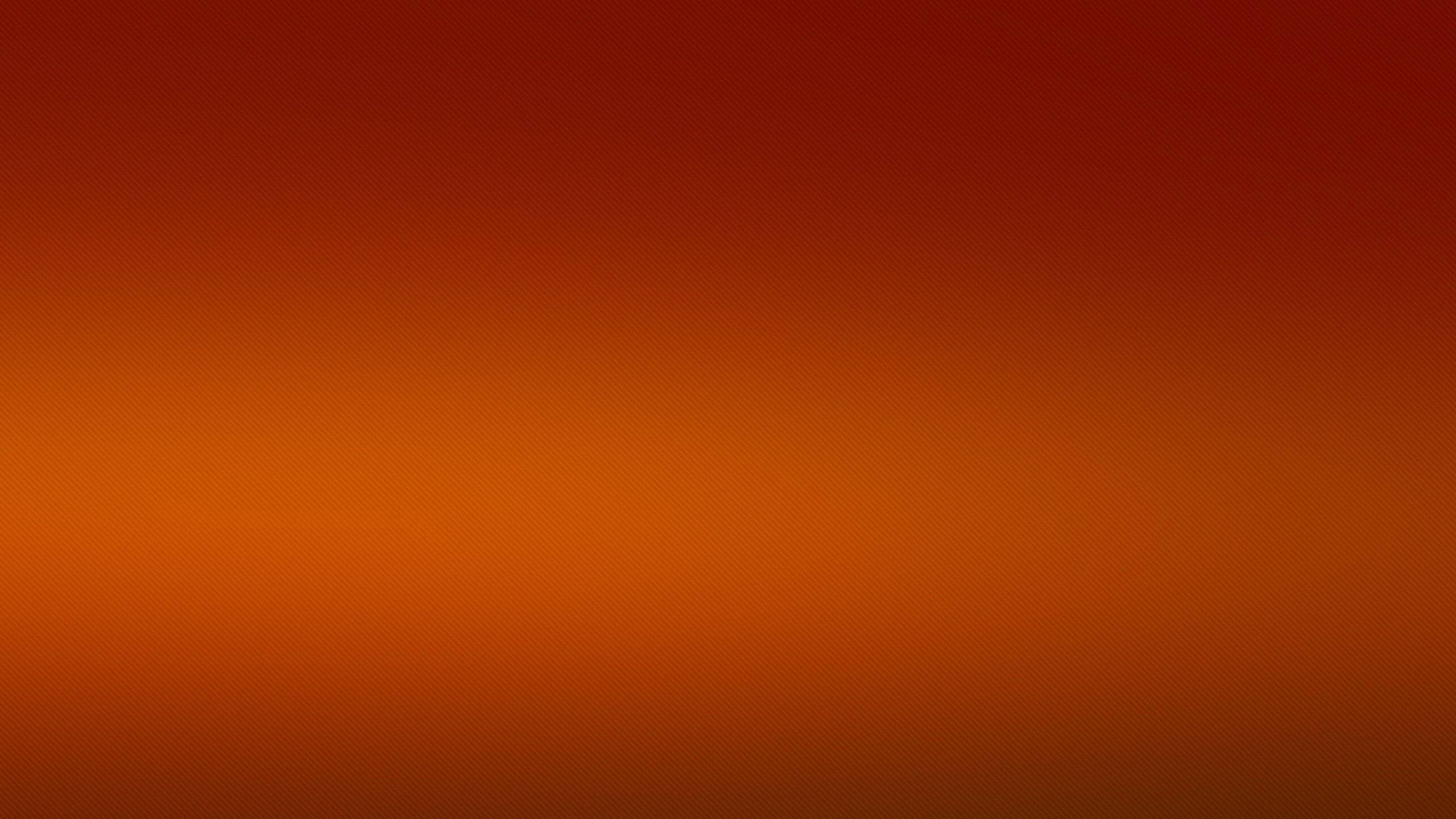 Solid Orange 桌布 壁紙 — 從深紅色到暖橙色的平滑漸變，整個畫面帶有微妙的點狀圖案。