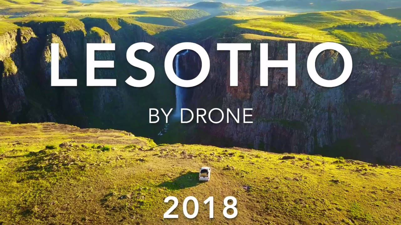 Lesotho 桌布 壁紙 — 從無人機俯瞰賴索托一輛孤獨的白色汽車停在長滿草的懸崖上，俯瞰著深綠色的峽谷和瀑布。