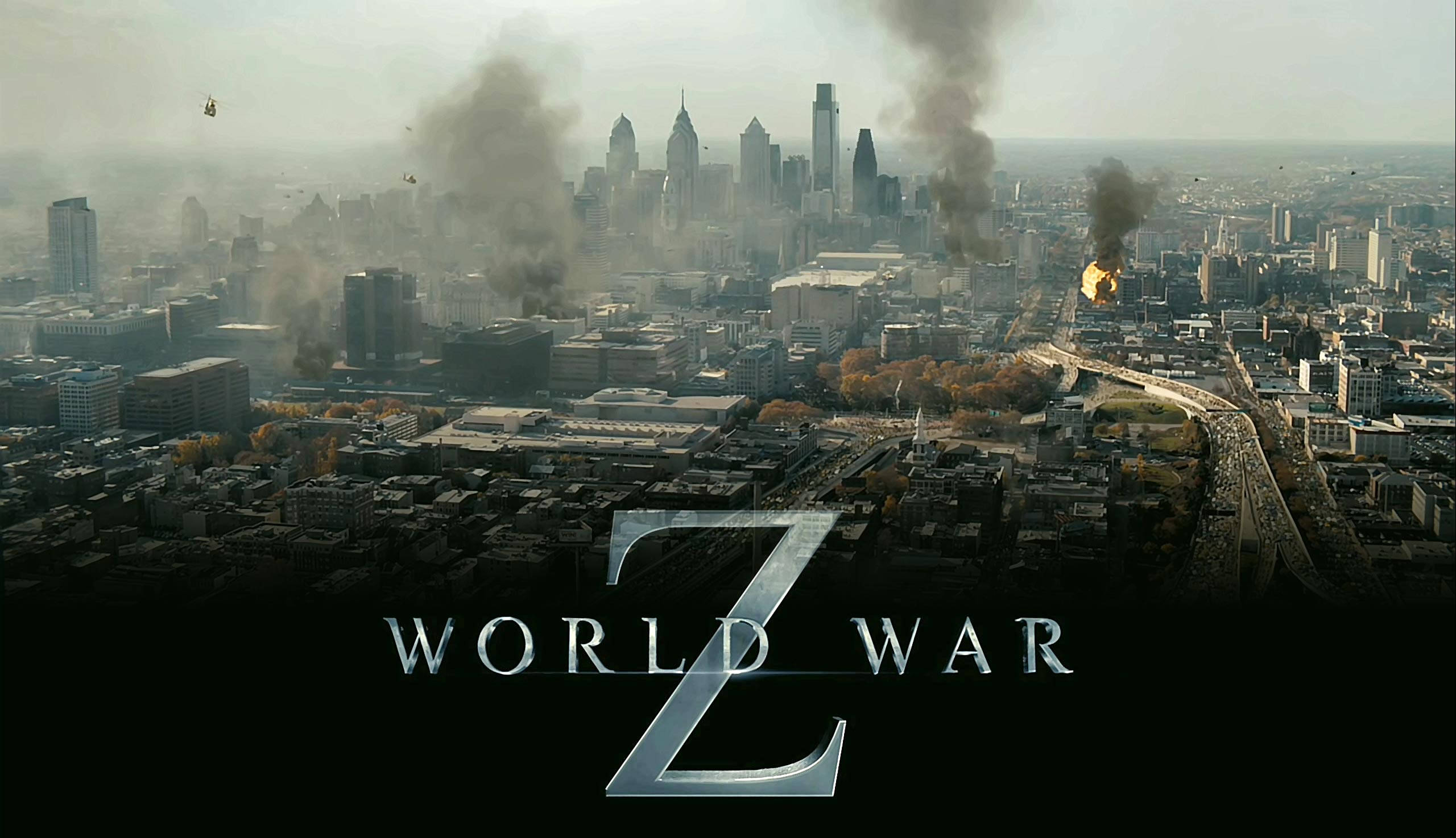 world war z 4K 桌布 壁紙 — 從空中俯瞰戰火摧殘的城市景觀，煙霧從爆炸中升起，摩天大樓在朦朧的天空下矗立。