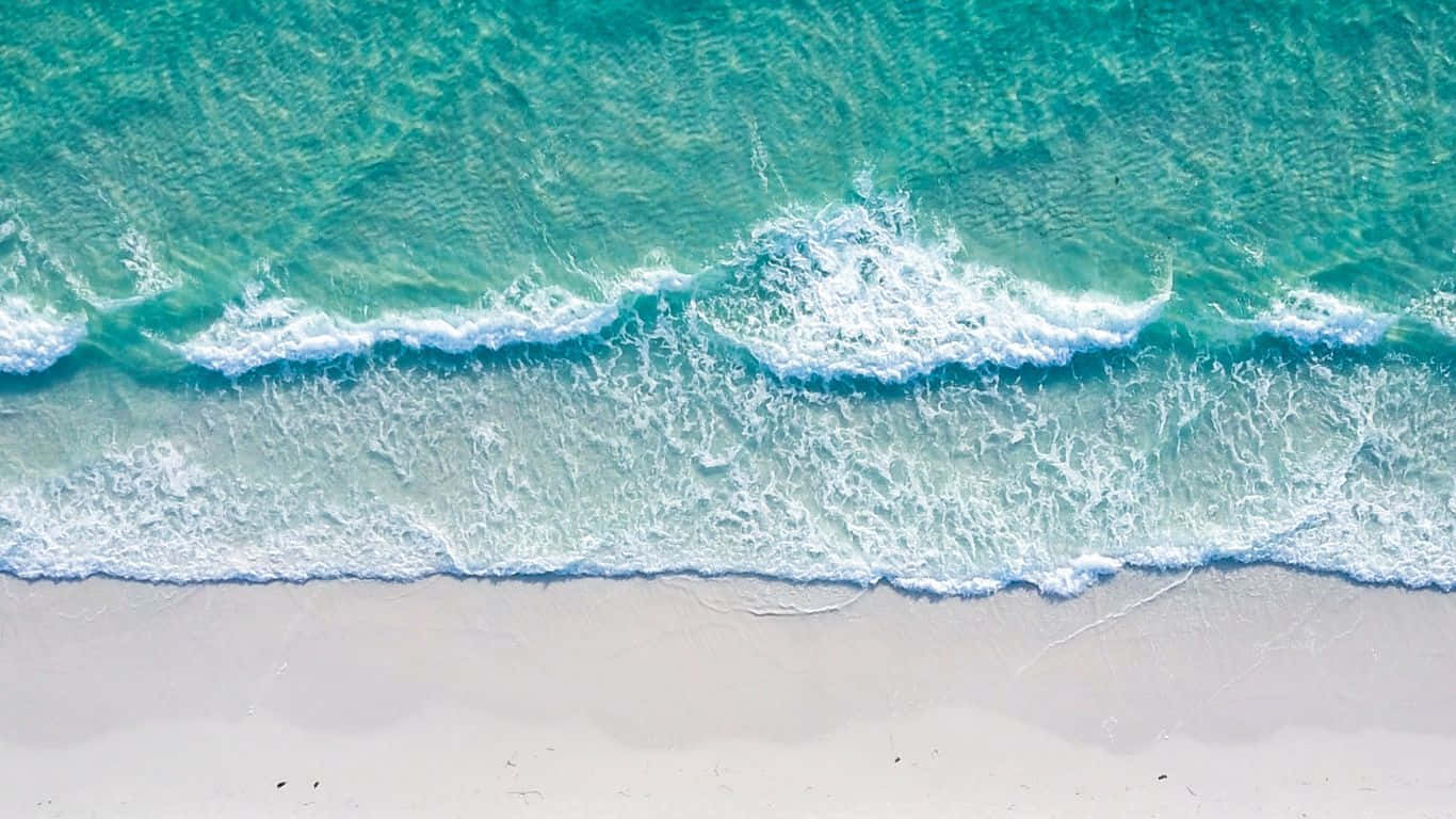 海灘 桌布 壁紙 — 從高空俯瞰，碧綠色的海浪拍打著純淨的白色沙灘。