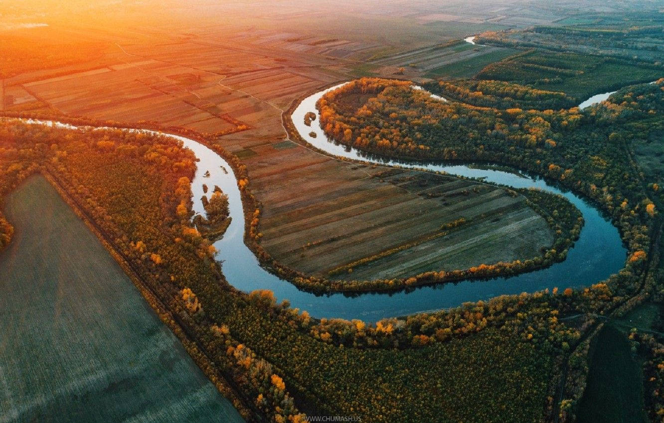 Moldova 桌布 壁紙 — 從高空俯瞰，蜿蜒的河流在金色夕陽下穿過秋日森林和農田。