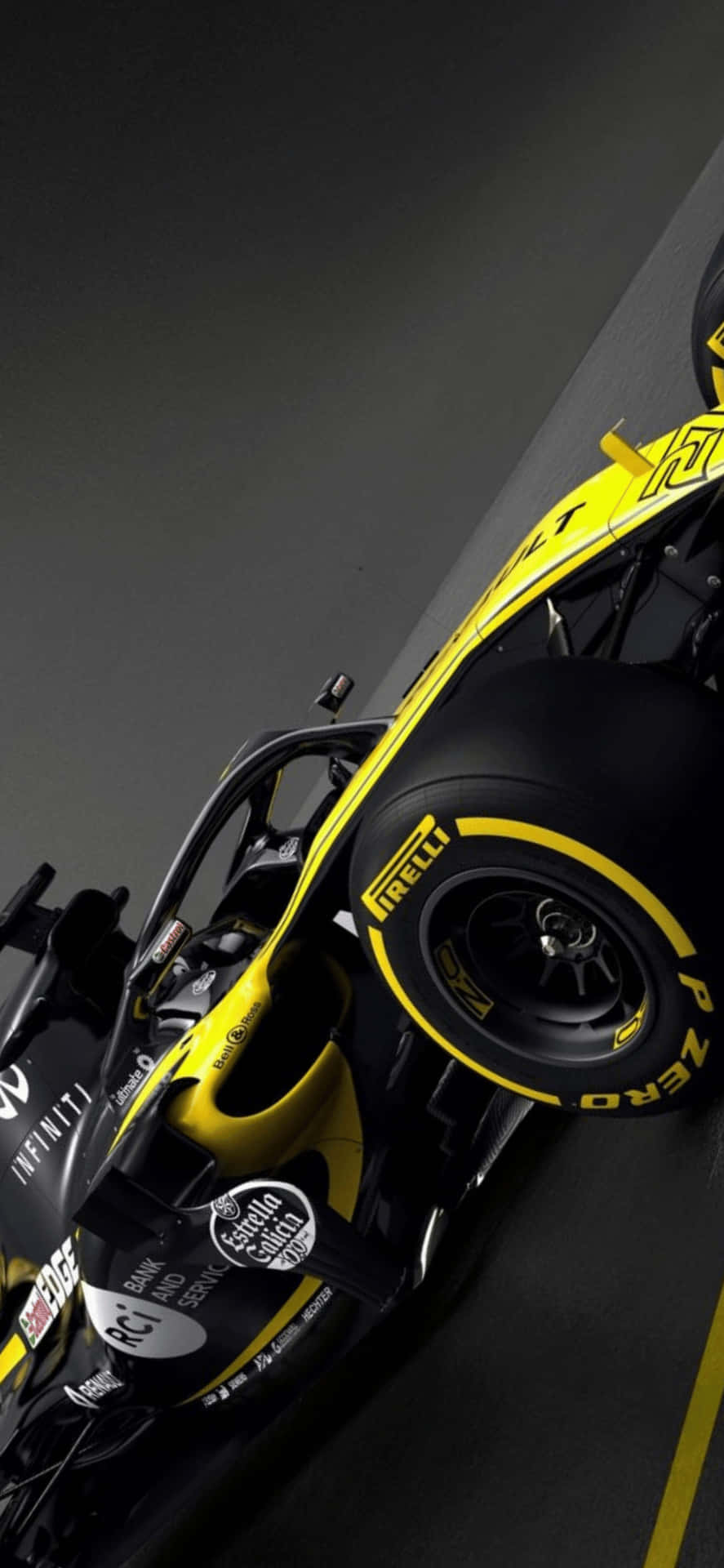F1 2018 桌布 壁紙 — 從高角度拍攝一輛黑色和黃色的 Formula 1 賽車，配備 Pirelli 輪胎，在黑暗的賽道表面上。
