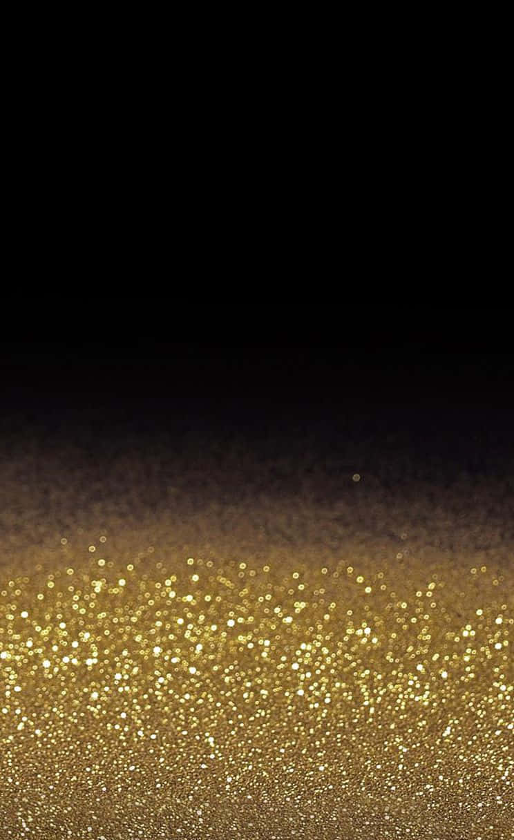 Black And Gold Glitter 桌布 壁紙 — 從黑色漸變到閃爍的金色亮粉顆粒場。
