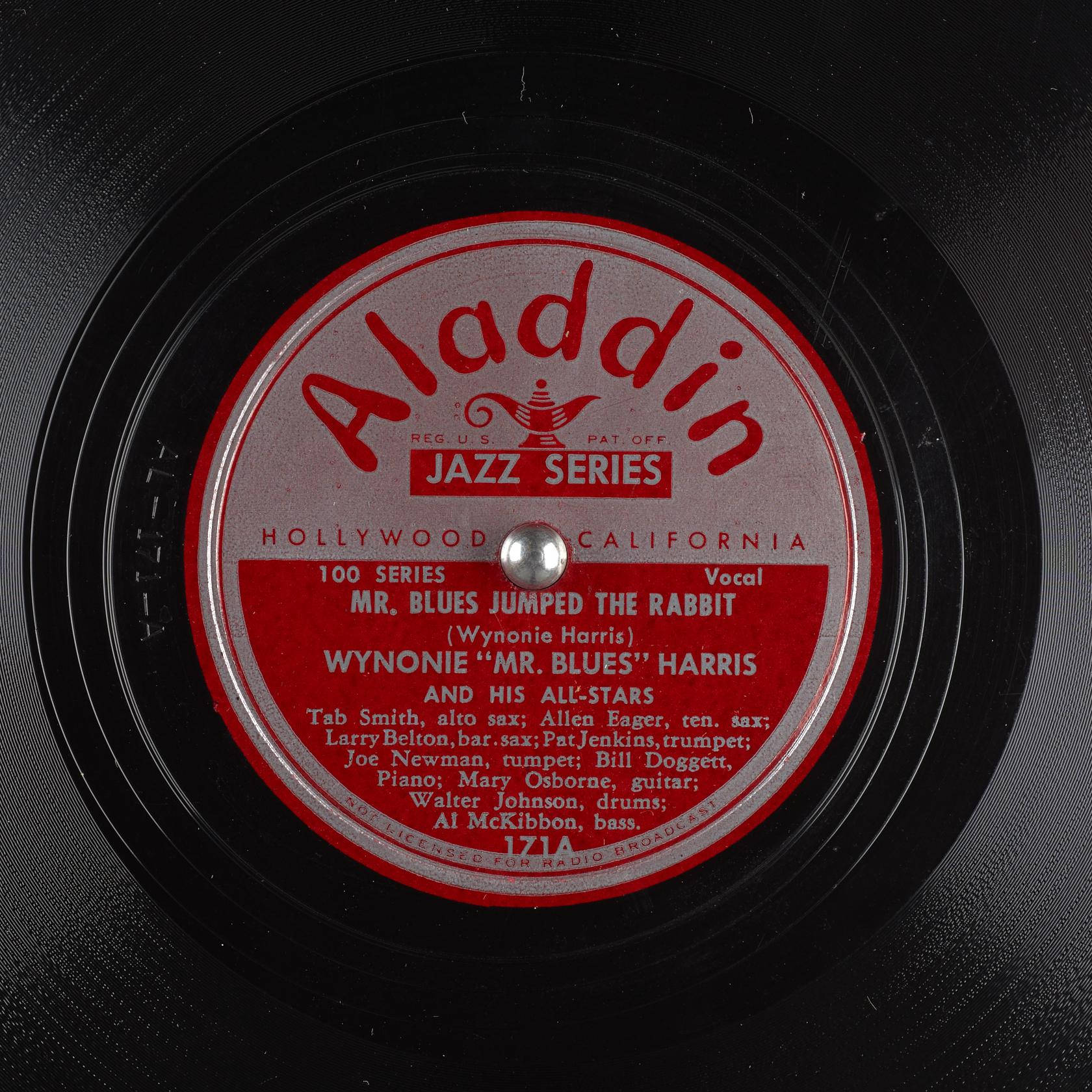 vinyl 桌布 壁紙 — 復古 Aladdin Jazz Series 黑膠唱片標籤的特寫，帶有紅色和銀色文字，詳細介紹 Wynonie Harris 的歌曲 Mr Blues Jumped The Rabbit。