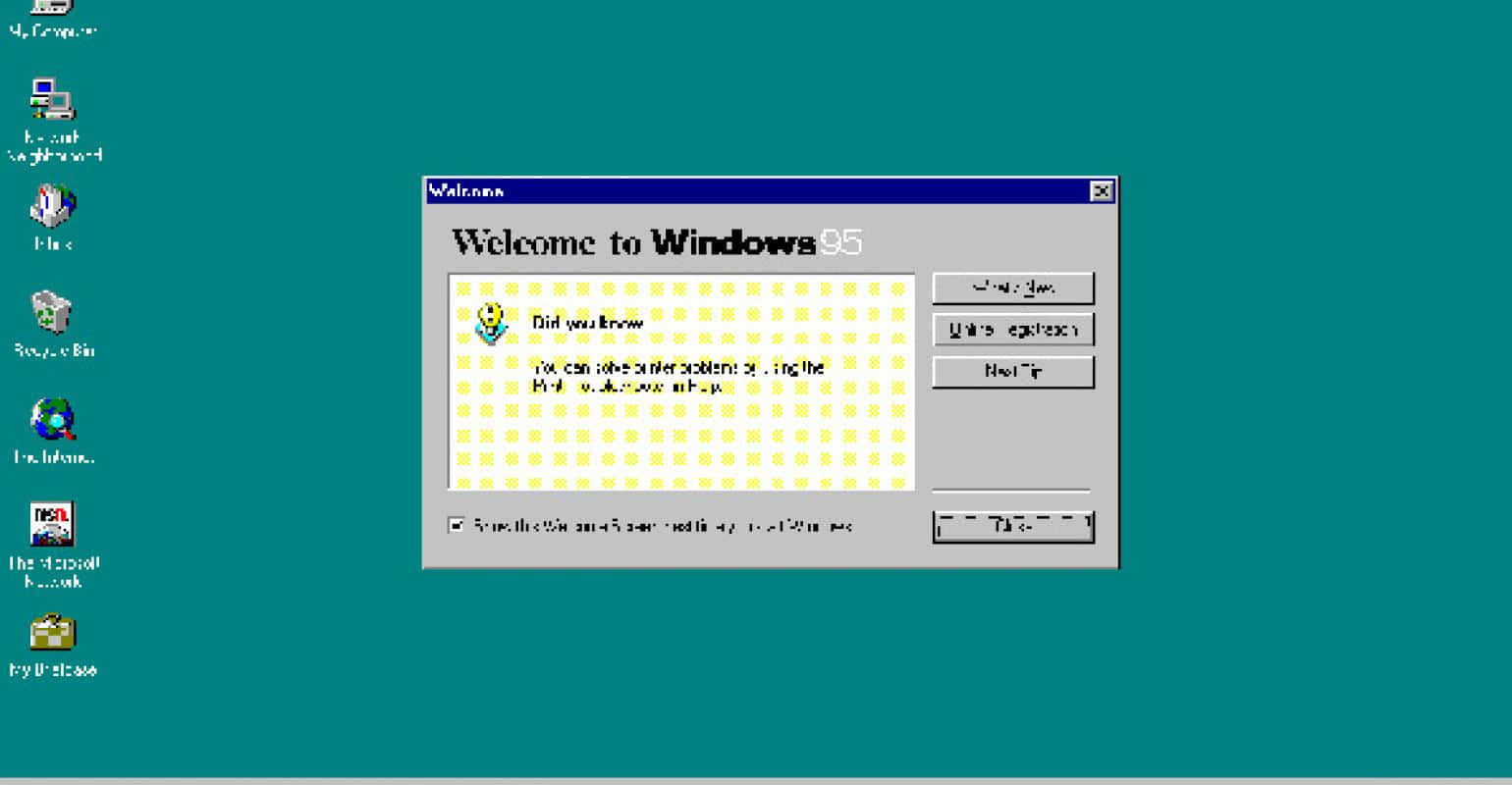 Windows 95 動態圖 桌布 壁紙 — 復古 Windows 95 桌面，帶有青綠色背景和經典歡迎對話框。