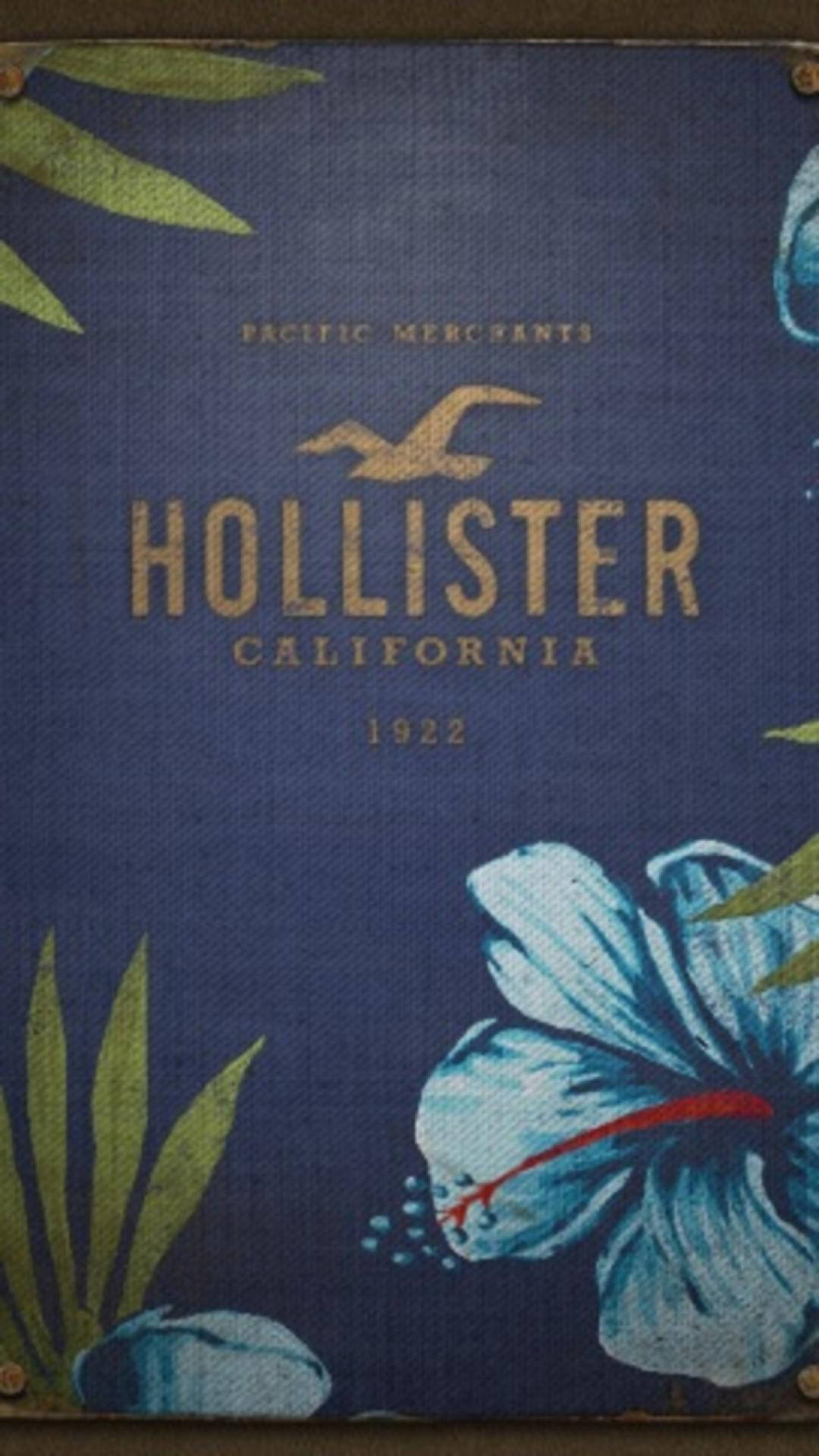Hollister 桌布 壁紙 — 復古Hollister California 1922標誌，位於帶有紋理的深藍色布料上，搭配熱帶木槿和綠葉。