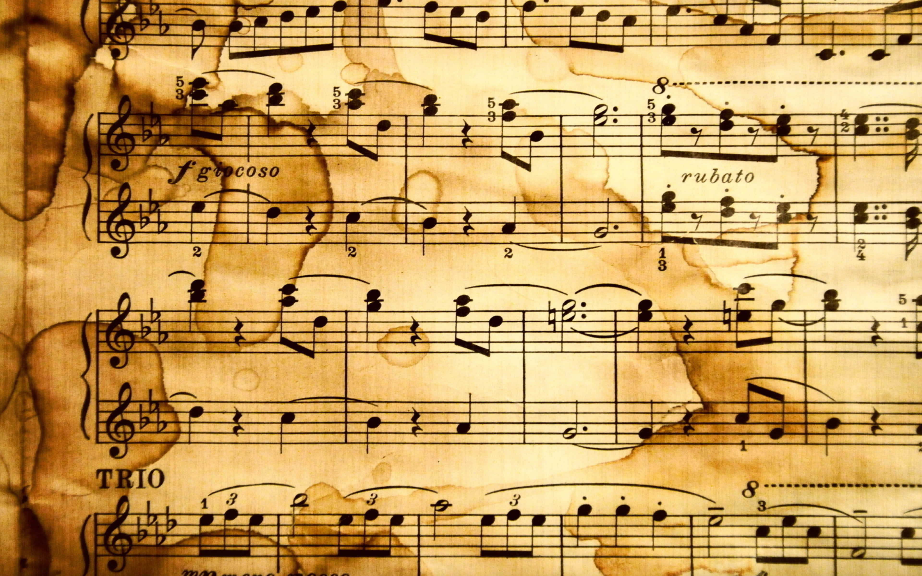 Music Notes 桌布 壁紙 — 復古樂譜，帶有優雅音符和義大利術語，書寫在陳舊、有污漬的羊皮紙上。