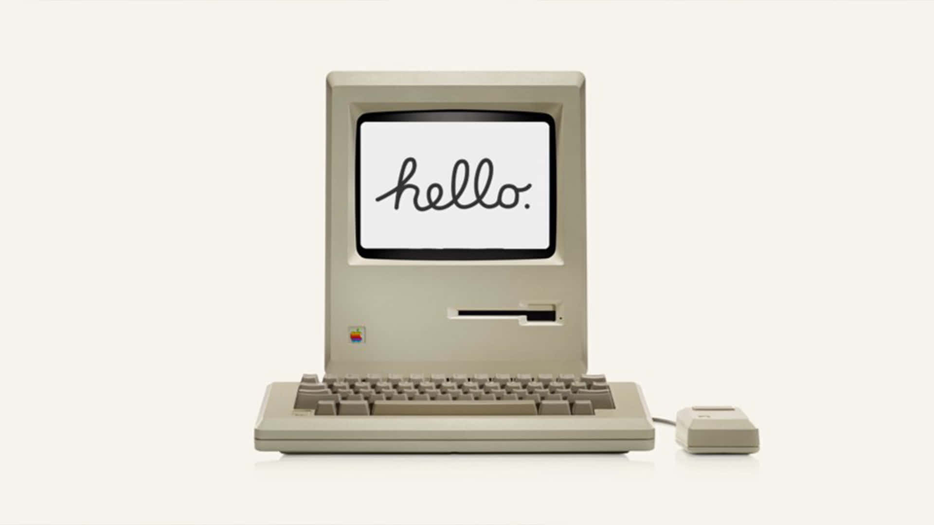 Hello 桌布 壁紙 — 復古米色 Macintosh 電腦，螢幕上以草書顯示 'hello.'，背景簡潔。