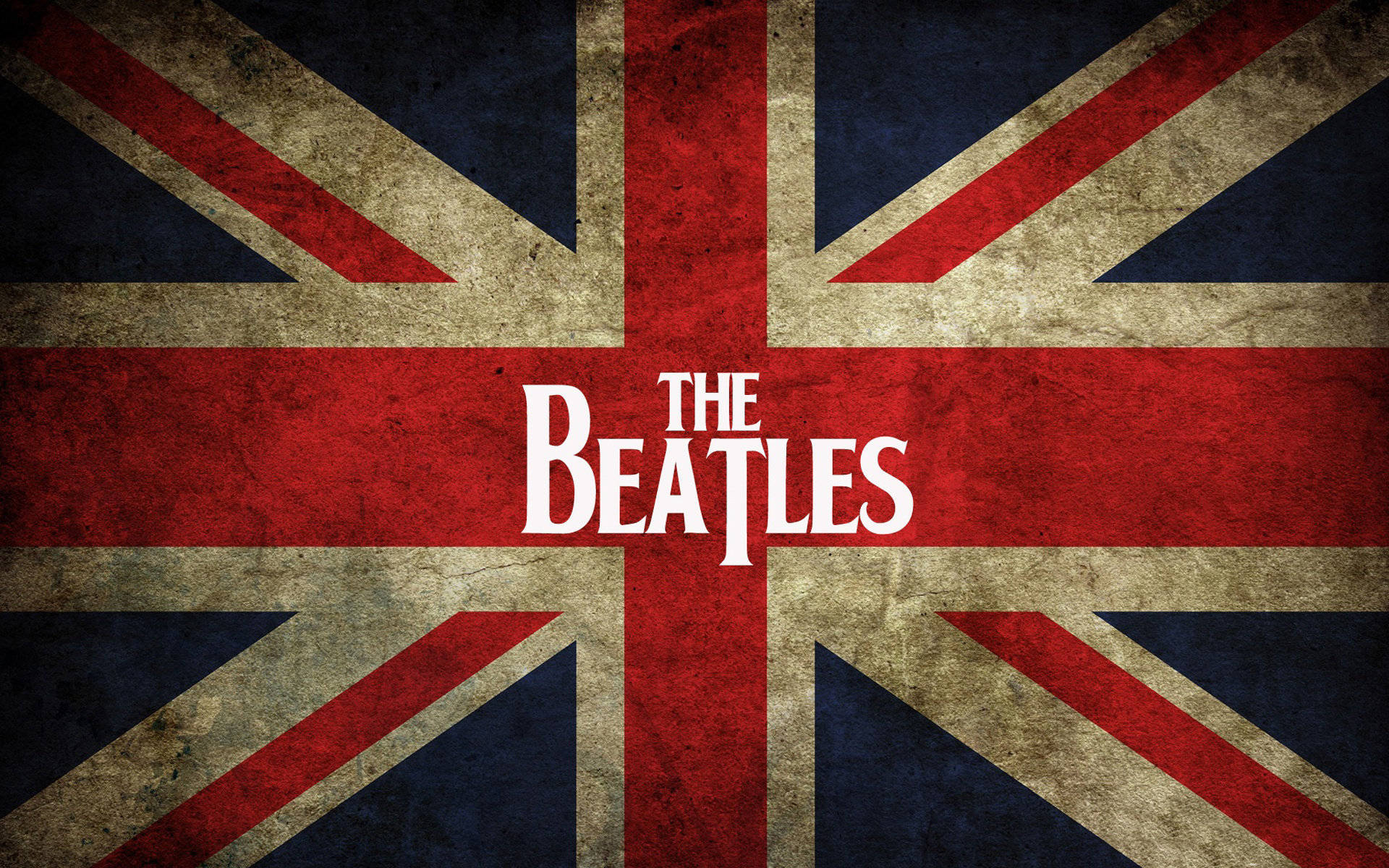 the beatles 桌布 壁紙 — 復古英國國旗，帶有磨損紋理，紅色十字中央有粗體白色文字寫著 The Beatles。