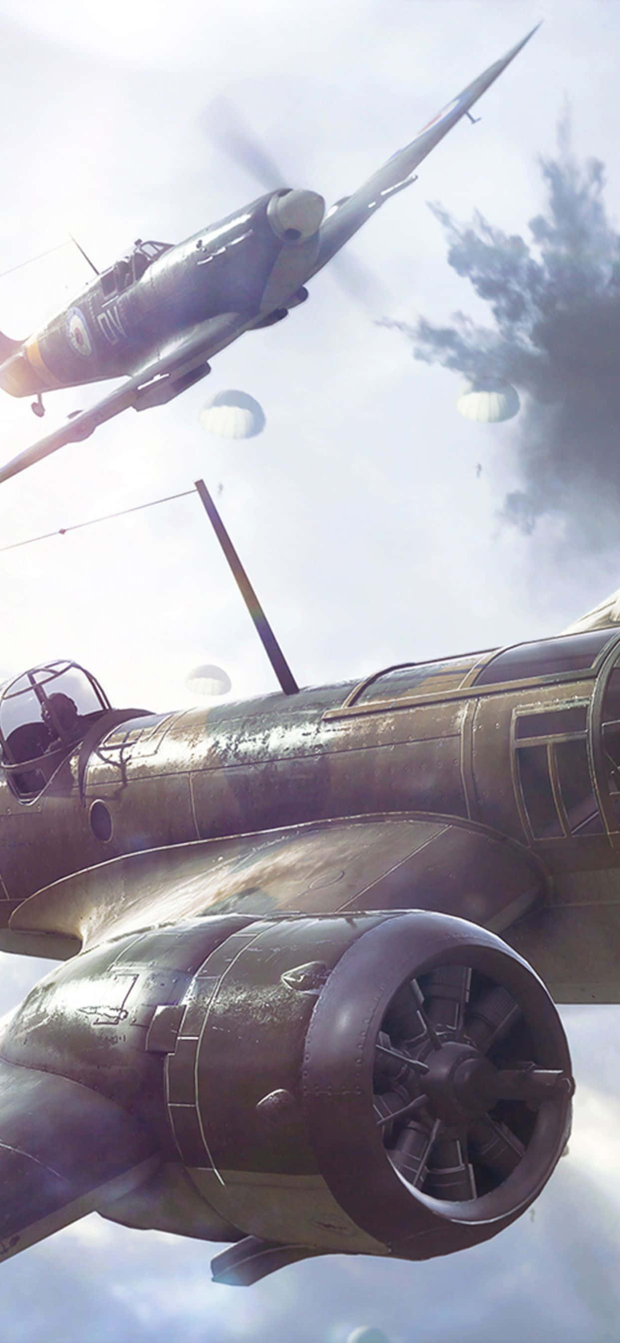 Battlefield V 桌布 壁紙 — 復古軍用飛機在陰雲密佈的天空中翱翔，下方有降落傘飄蕩，形成戲劇性的空中場景。