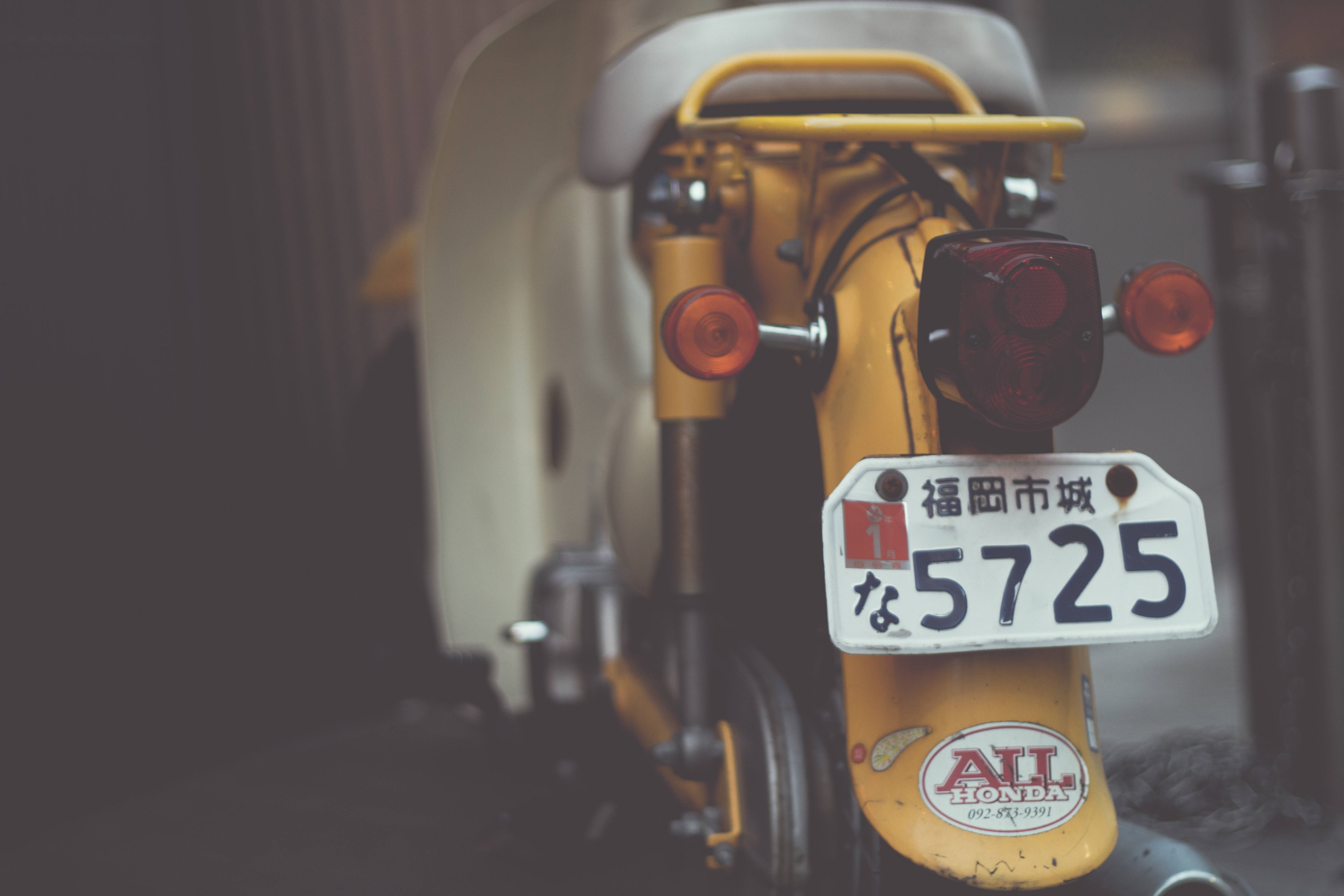 機車 桌布 壁紙 — 復古黃色機車後部特寫，帶有日本車牌和紅色尾燈。