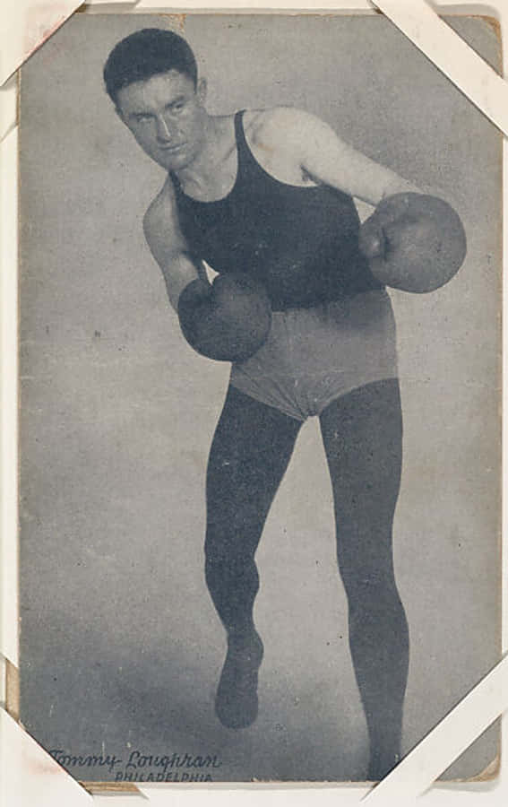 Boxing 桌布 壁紙 — 復古黑白肖像，一名拳擊手戴著手套和短褲，在純色攝影棚背景前擺出戰鬥姿勢。