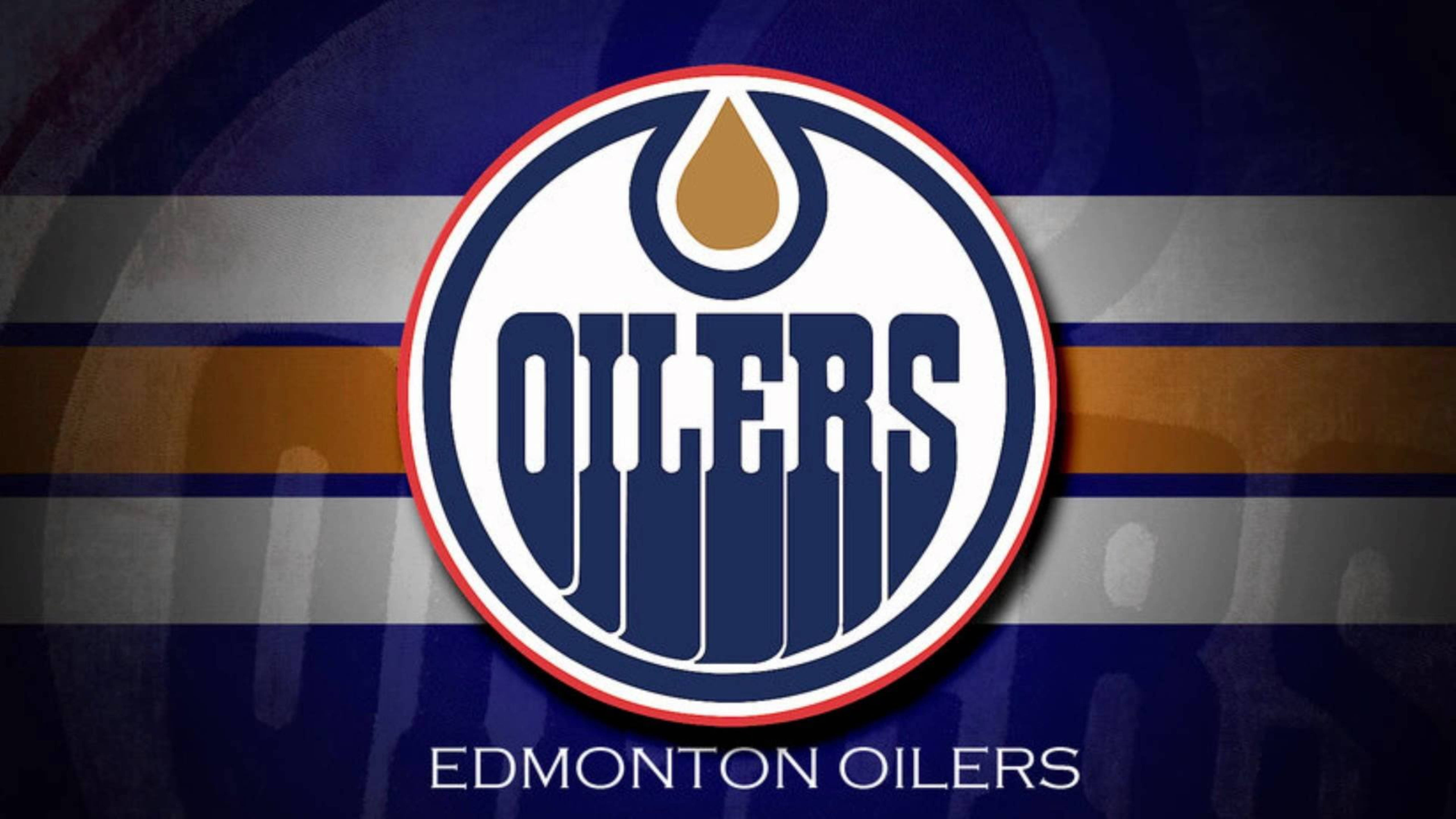 Oilers 桌布 壁紙 — 愛德蒙頓油人隊標誌居中，背景為藍灰色和金色條紋，下方有球隊名稱。