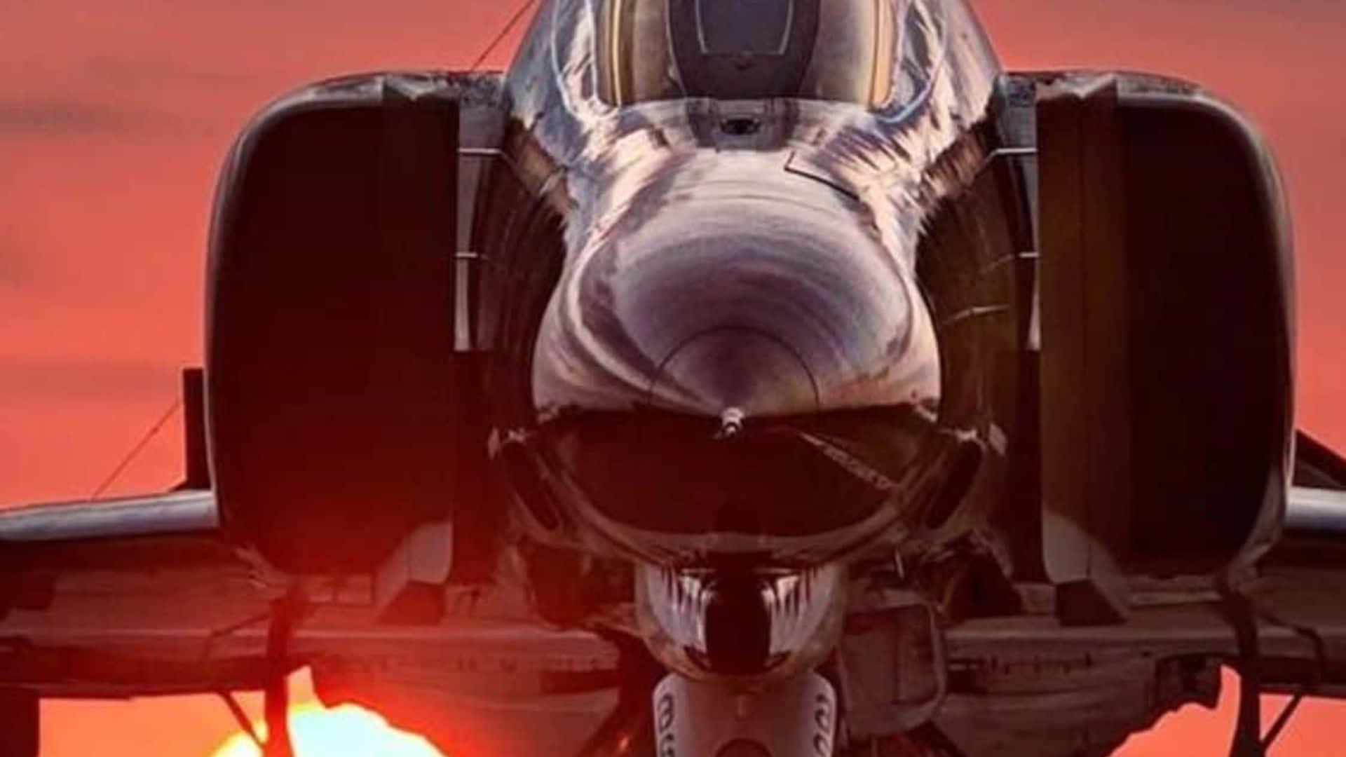 1920x1080 Jumbo Jets 桌布 壁紙 — 戰鬥機的機頭在熾熱的夕陽天空下閃爍，引擎排氣管發出光芒。