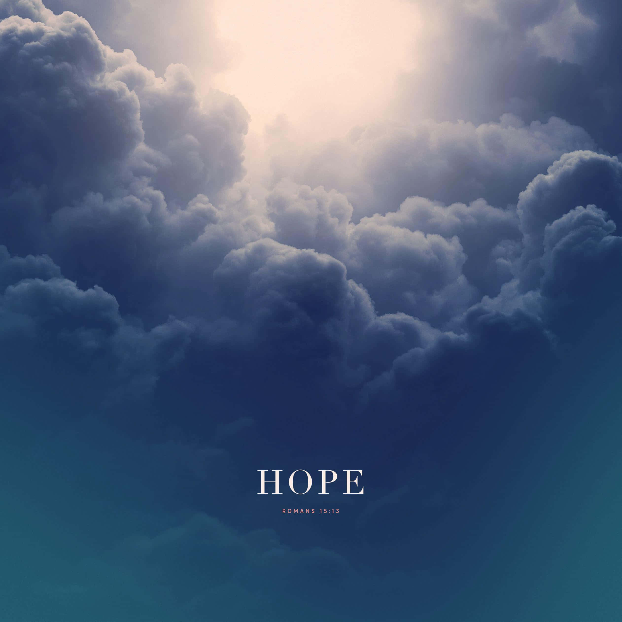 hope 桌布 壁紙 — 戲劇性的烏雲散開，露出燦爛的陽光，下方中央有希望一詞和羅馬書15:13。