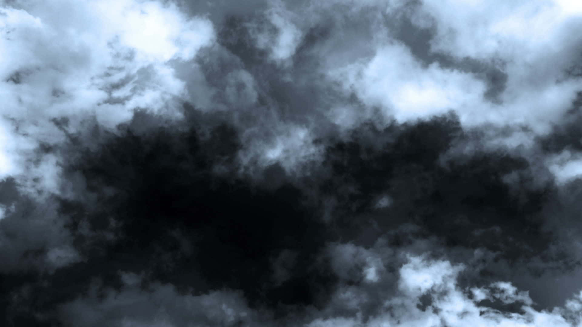 Stormy 桌布 壁紙 — 戲劇性的風暴雲在單色天空中旋轉，明亮白色與深黑色之間形成鮮明對比。