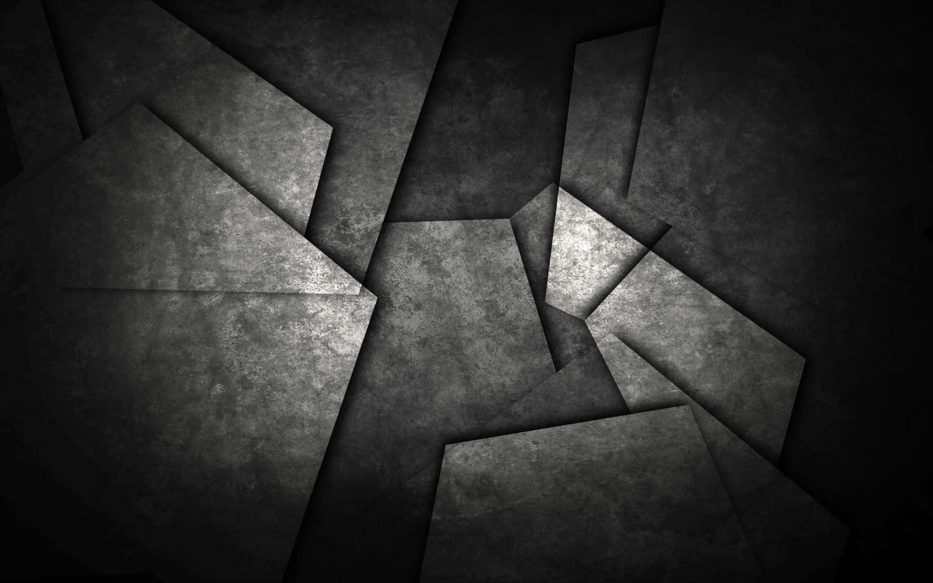 暗色抽象動態圖 桌布 壁紙 — 抽象的深灰色幾何碎片，帶有紋理表面和戲劇性燈光，營造出陰鬱的工業背景。