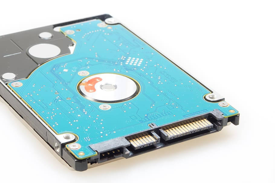 Processor 桌布 壁紙 — 拆解硬碟的特寫，露出藍色電路板和金屬碟片，背景為白色。
