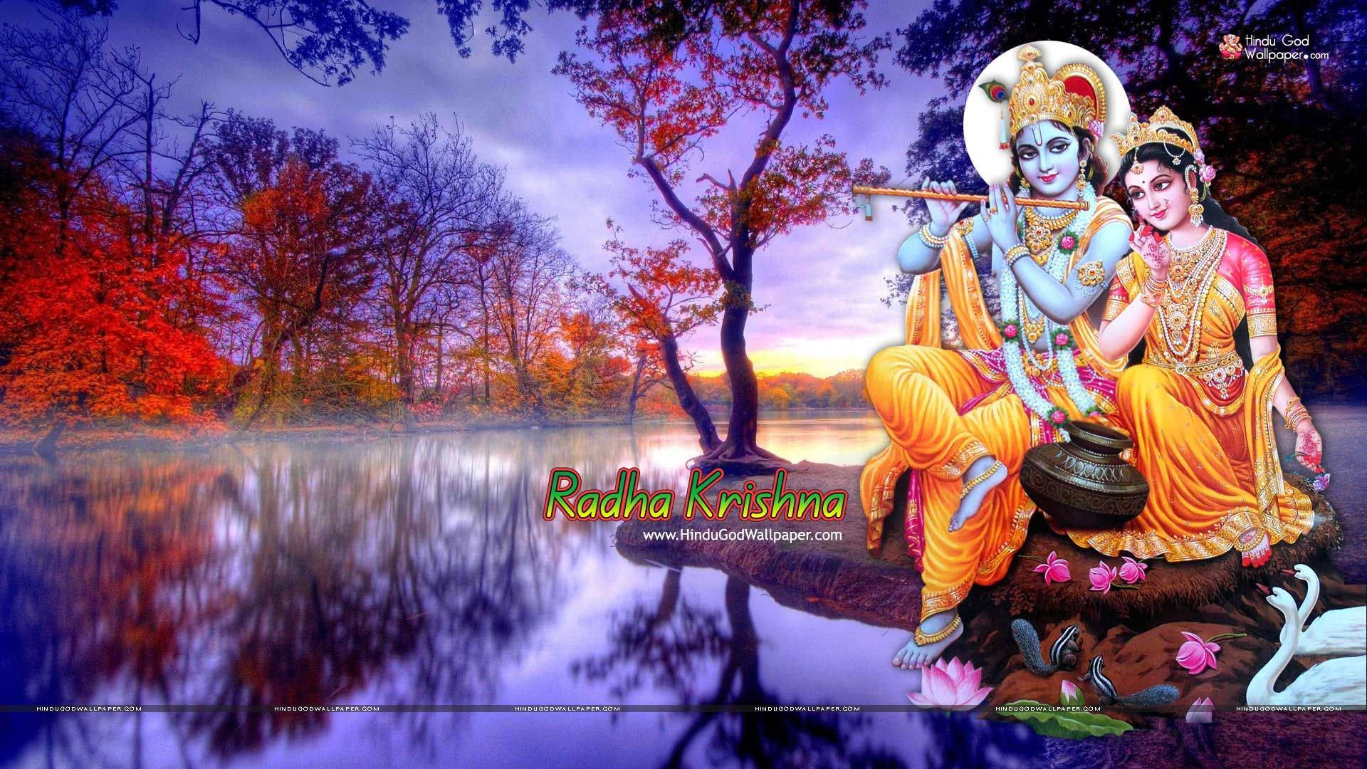 Krishna Desktop 桌布 壁紙 — 拉妲和克里希納靜靜地坐在一個倒映著周圍景色的湖邊，周圍是色彩繽紛的秋樹，天空是黃昏時分。