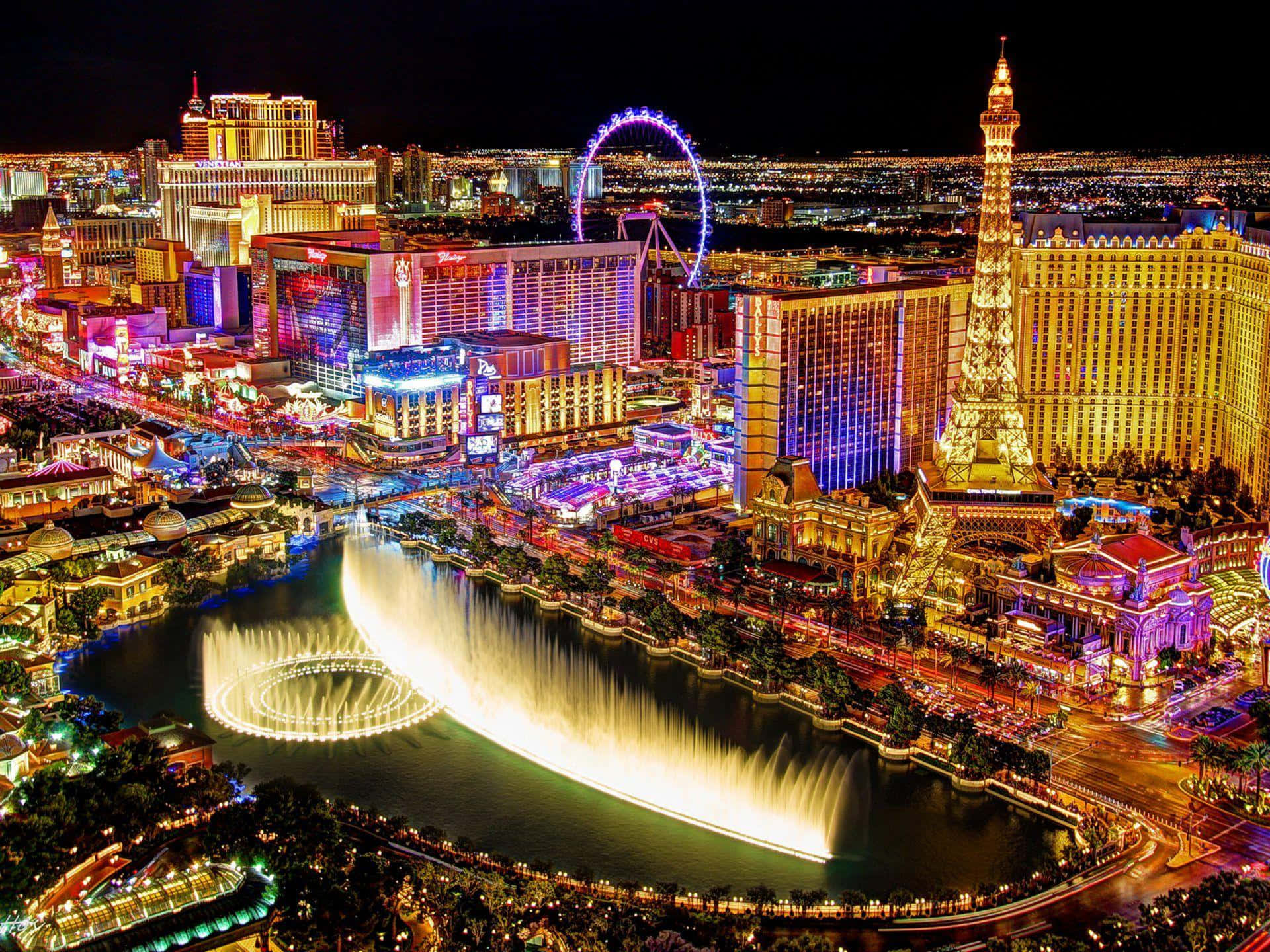 Las Vegas 桌布 壁紙 — 拉斯維加斯令人驚嘆的夜間空中景觀，在黑暗的天空下展示著燈光璀璨的噴泉和標誌性酒店。