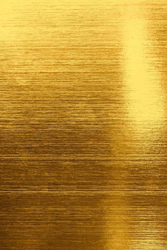 金色動態 桌布 壁紙 — 拉絲金金屬的特寫，帶有水平線條和明亮的漸變高光。
