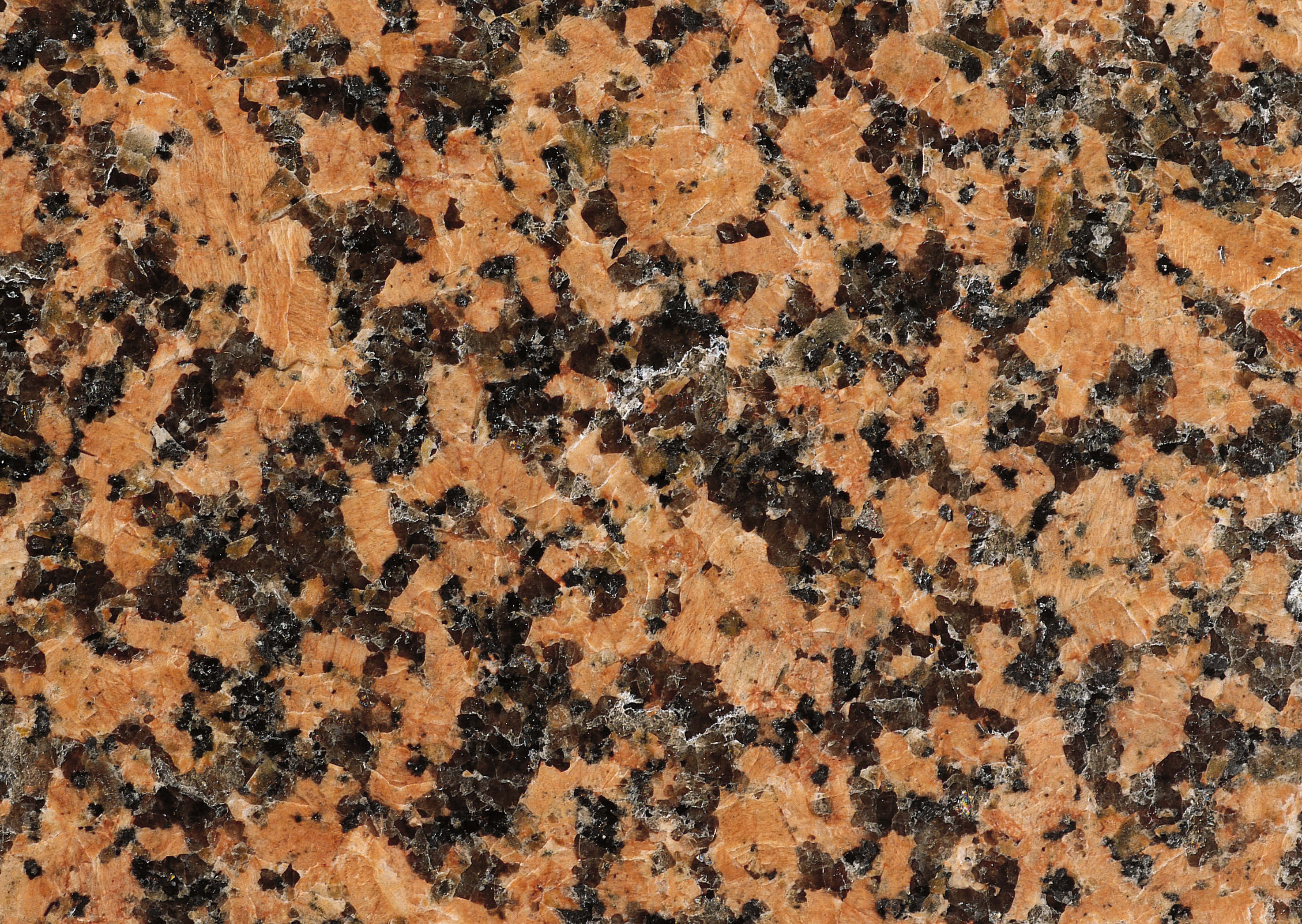 Granite 桌布 壁紙 — 拋光花崗岩表面的特寫，帶有橙色、棕色和黑色漩渦狀礦物圖案。
