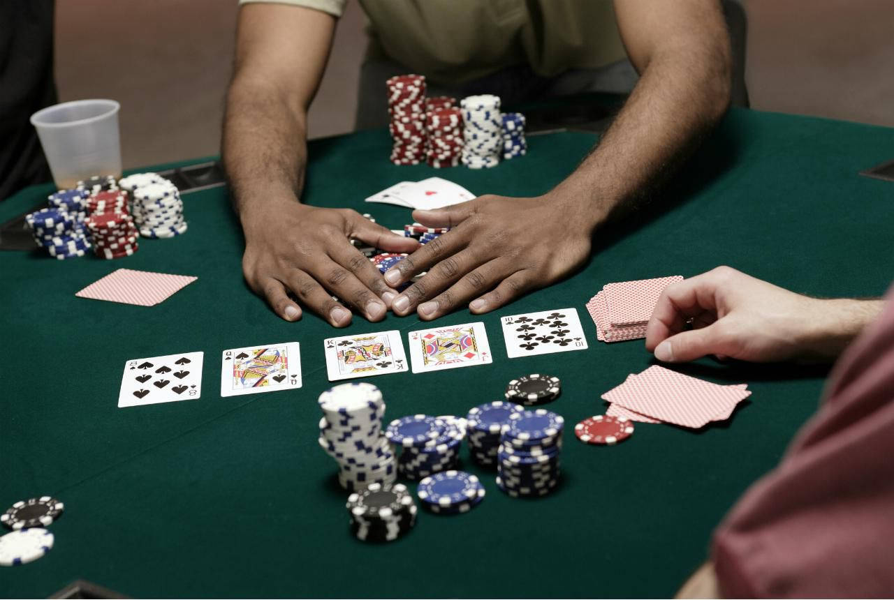 Playing Cards 桌布 壁紙 — 撲克玩家雙手圍繞綠色氈桌的特寫，桌上散落著紙牌和彩色籌碼。