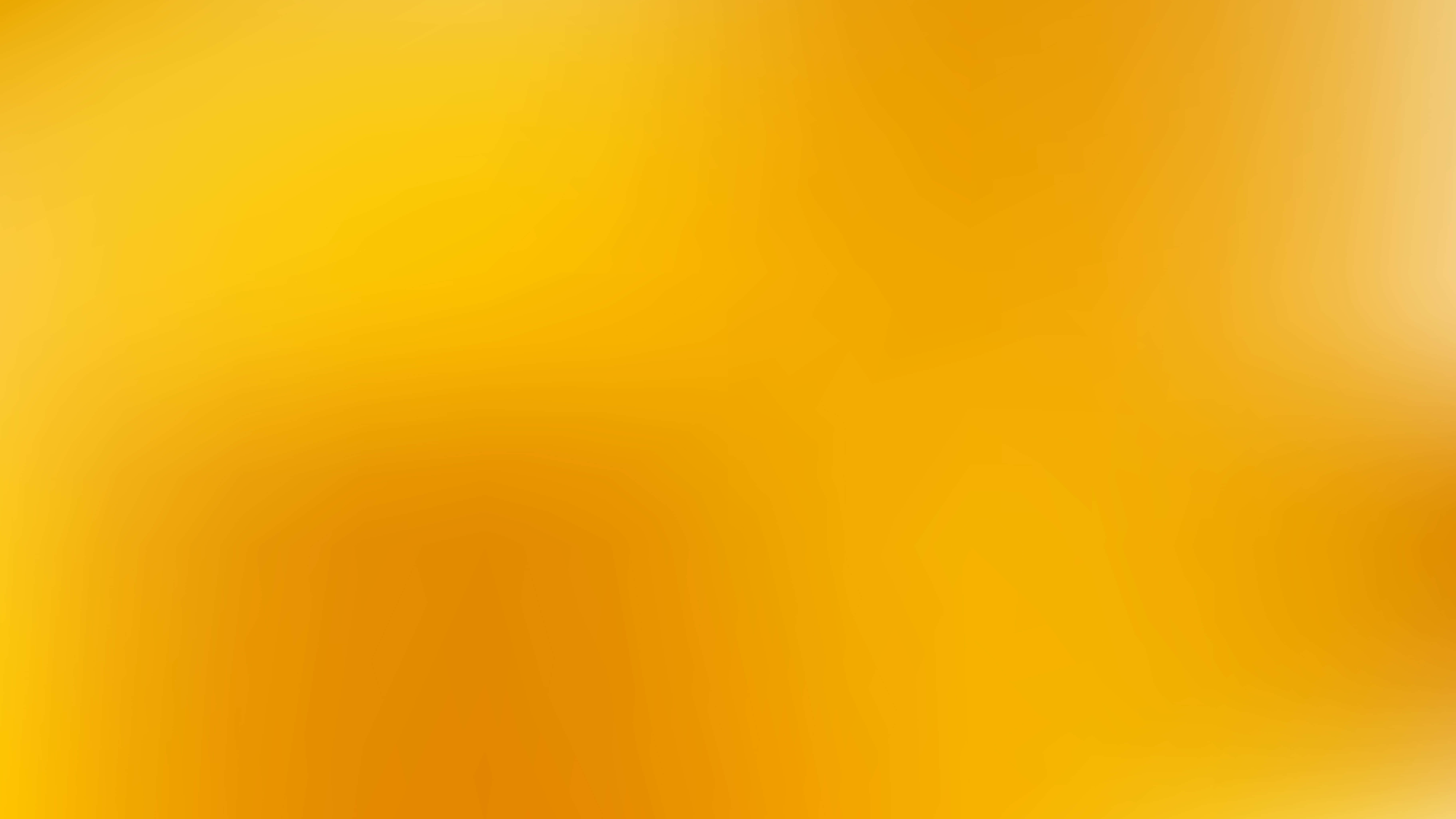 Light Orange 桌布 壁紙 — 整個畫面呈現溫暖金黃色柔和漸變至琥珀色調。