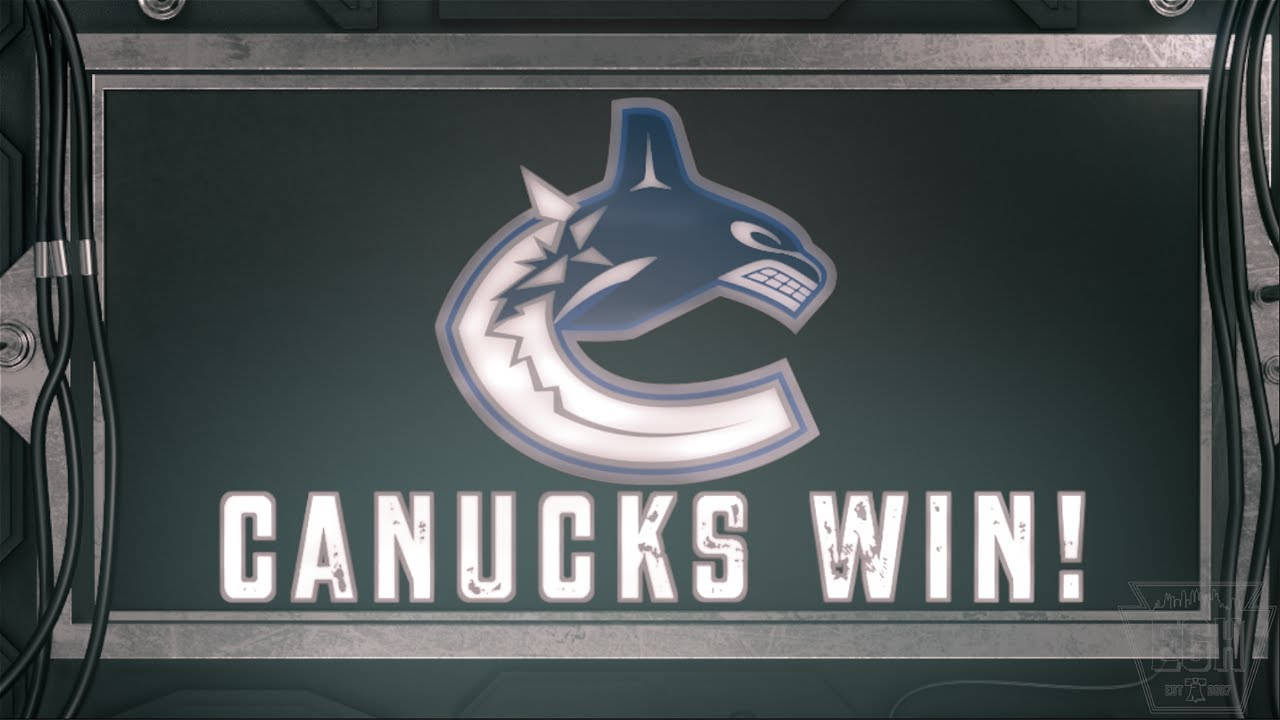 Vancouver 桌布 壁紙 — 數位顯示器顯示溫哥華加人隊標誌及粗體白色文字「CANUCKS WIN!」，螢幕深色，周圍環繞工業金屬和電纜。