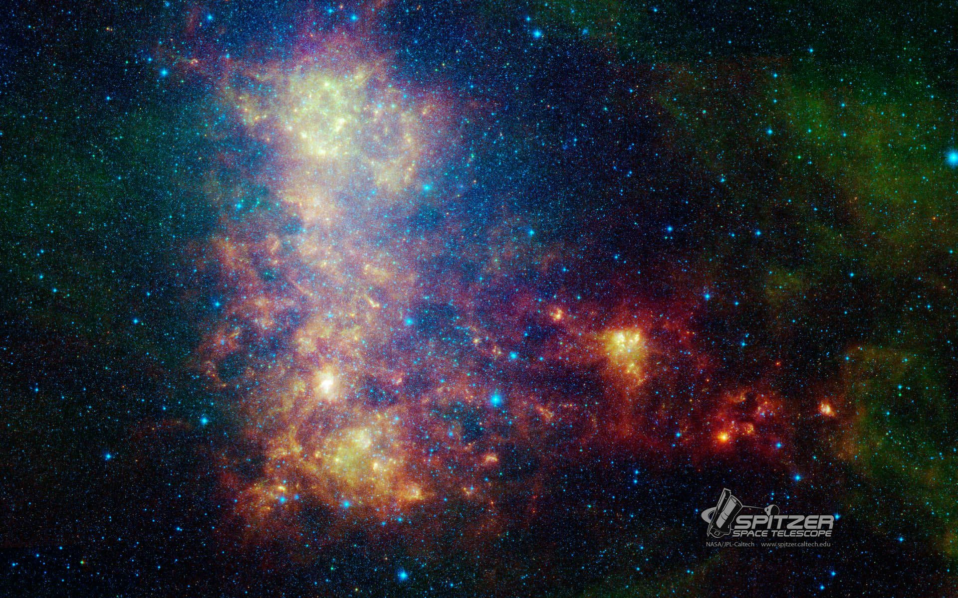 NASA 動態圖片 桌布 壁紙 — 斯皮策太空望遠鏡捕捉到的一個充滿活力的宇宙星雲，在星場背景下散發著橙色、黃色和藍色的色調。