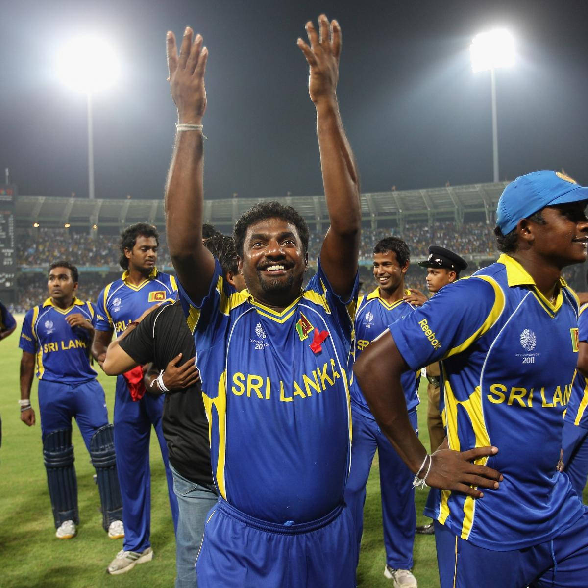 Sri Lanka Cricket 桌布 壁紙 — 斯里蘭卡板球隊球員在夜間泛光燈照亮的球場上慶祝勝利，向歡呼的球迷揮手。