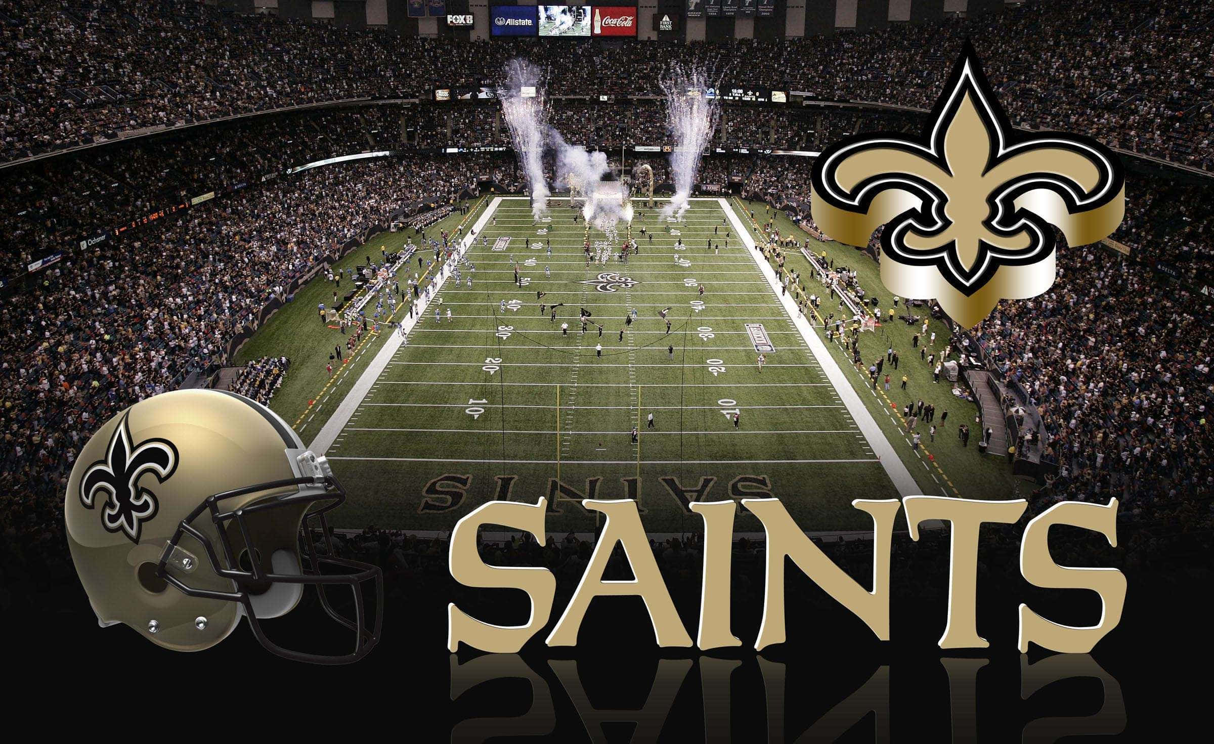 NFL Saints 桌布 壁紙 — 新奧爾良聖徒隊擁擠的體育場鳥瞰圖，煙火在球場上空爆炸，球隊標誌頭盔顯眼展示。