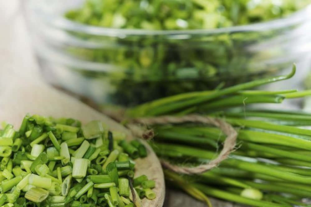 Food Photography 桌布 壁紙 — 新鮮切好的青蔥放在木匙中，旁邊是用麻繩捆綁的整根蔥莖和一個玻璃碗。