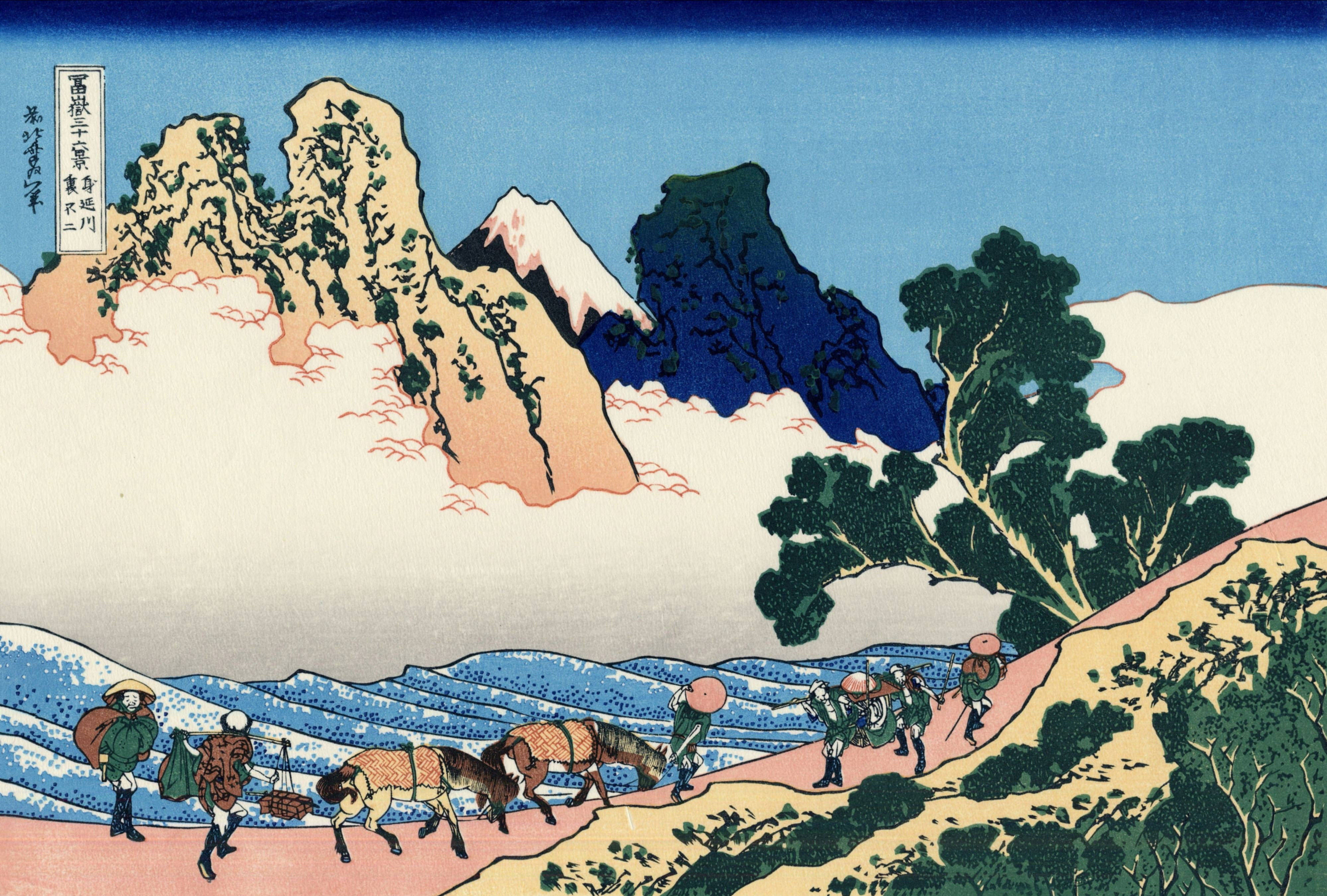 日式藝術 桌布 壁紙 — 旅客和馬匹在巍峨的山峰和漩渦狀雲層下，沿著蜿蜒的山路跋涉，這是一幅充滿活力的浮世繪版畫。