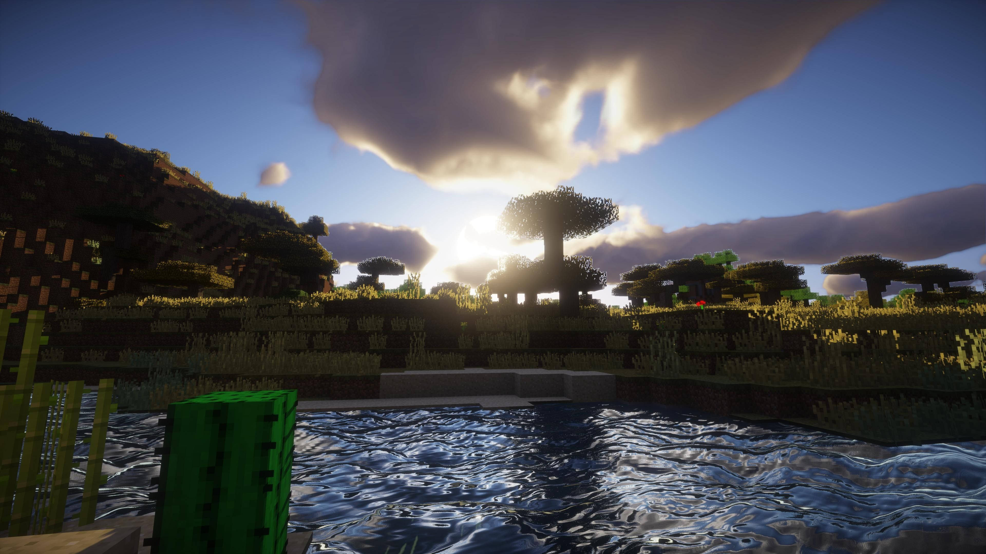 日落 桌布 壁紙 — 日落於一個像素風格、帶有樹木、水和山丘的方塊狀 Minecraft 景觀之上。