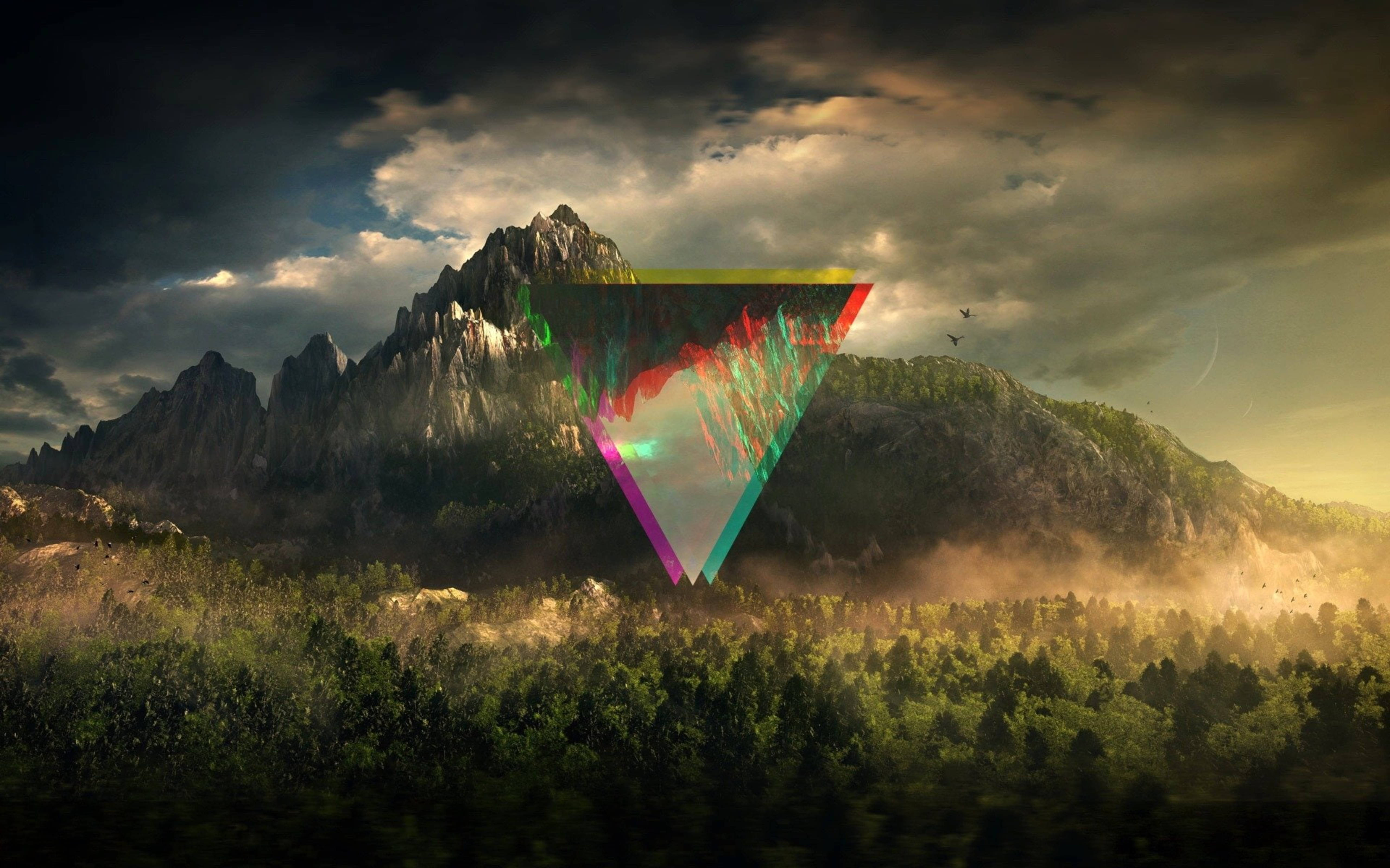 Polyscape 桌布 壁紙 — 日落時分，一座雄偉的山脈聳立在霧氣瀰漫的森林上方，一個發光的霓虹三角形懸浮於森林之上。