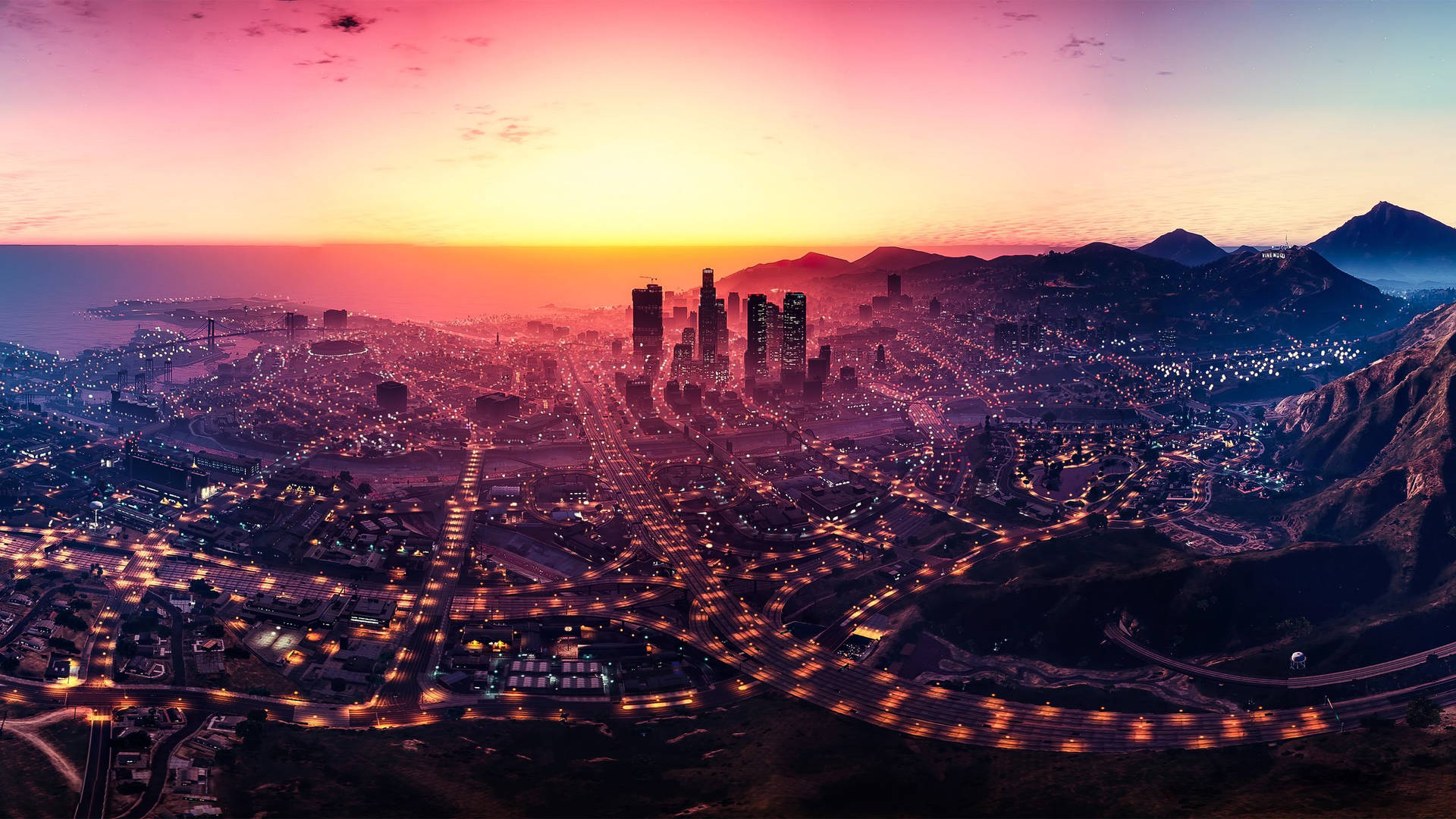 日落時分的城市景觀，閃爍的燈光和蜿蜒的道路。 — GTA 5 動圖 壁紙