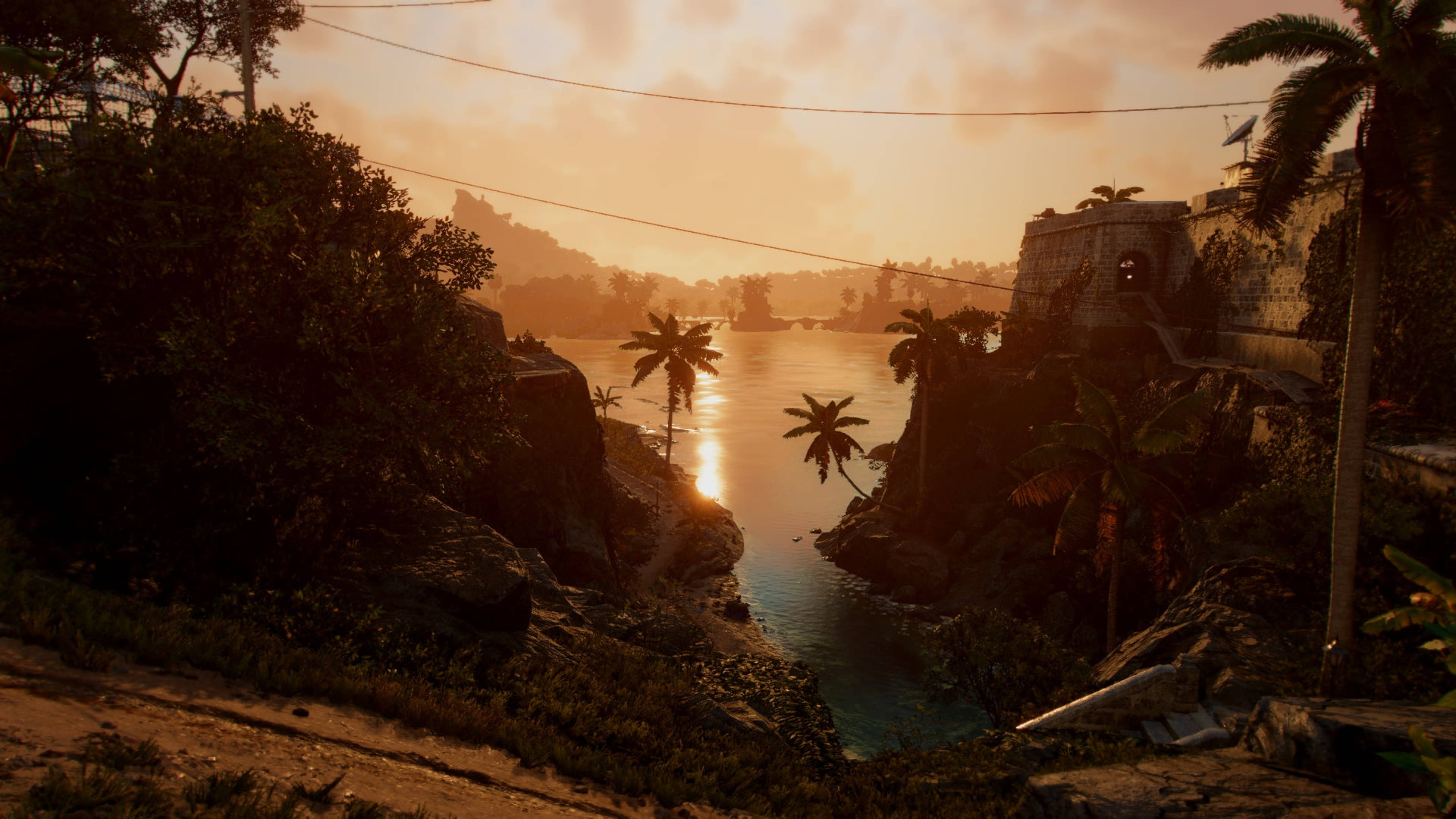 Far Cry 6 桌布 壁紙 — 日落照耀著熱帶海灣，有棕櫚樹和岩石海岸上的石頭堡壘。
