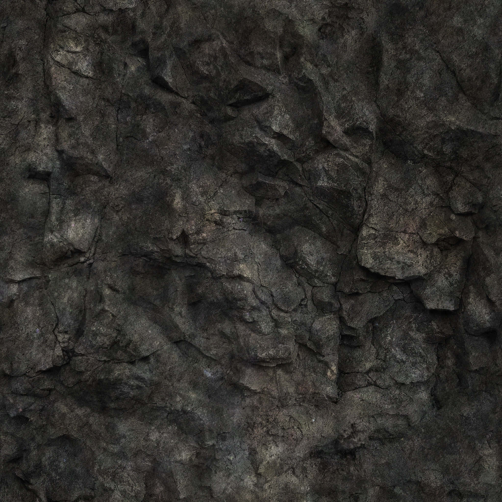 Dark Rock 桌布 壁紙 — 昏暗燈光下粗糙深灰色岩石的特寫，帶有深裂縫和鋸齒狀邊緣。