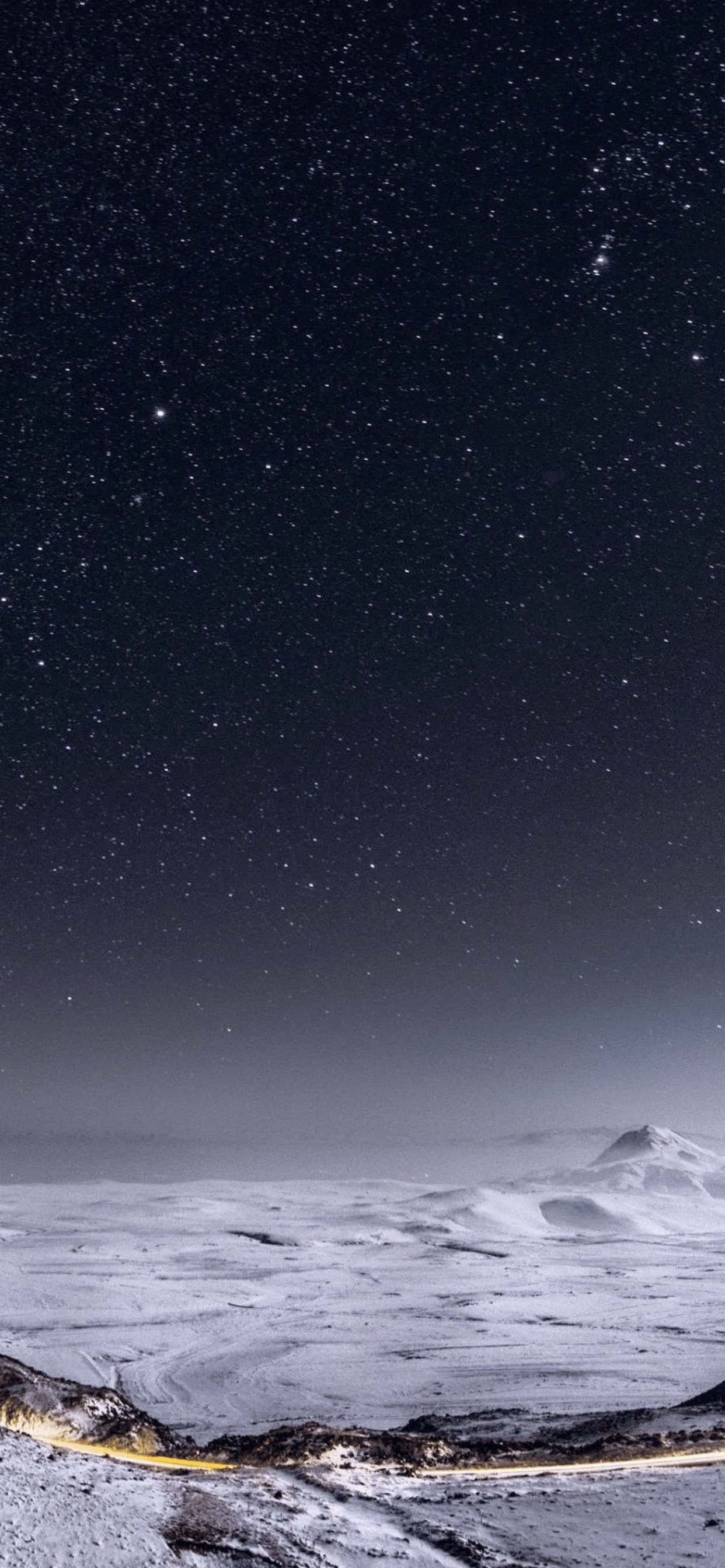 冬天 桌布 壁紙 — 星空夜空拱形覆蓋在積雪的山脈上，一條發光的道路蜿蜒穿過前景。
