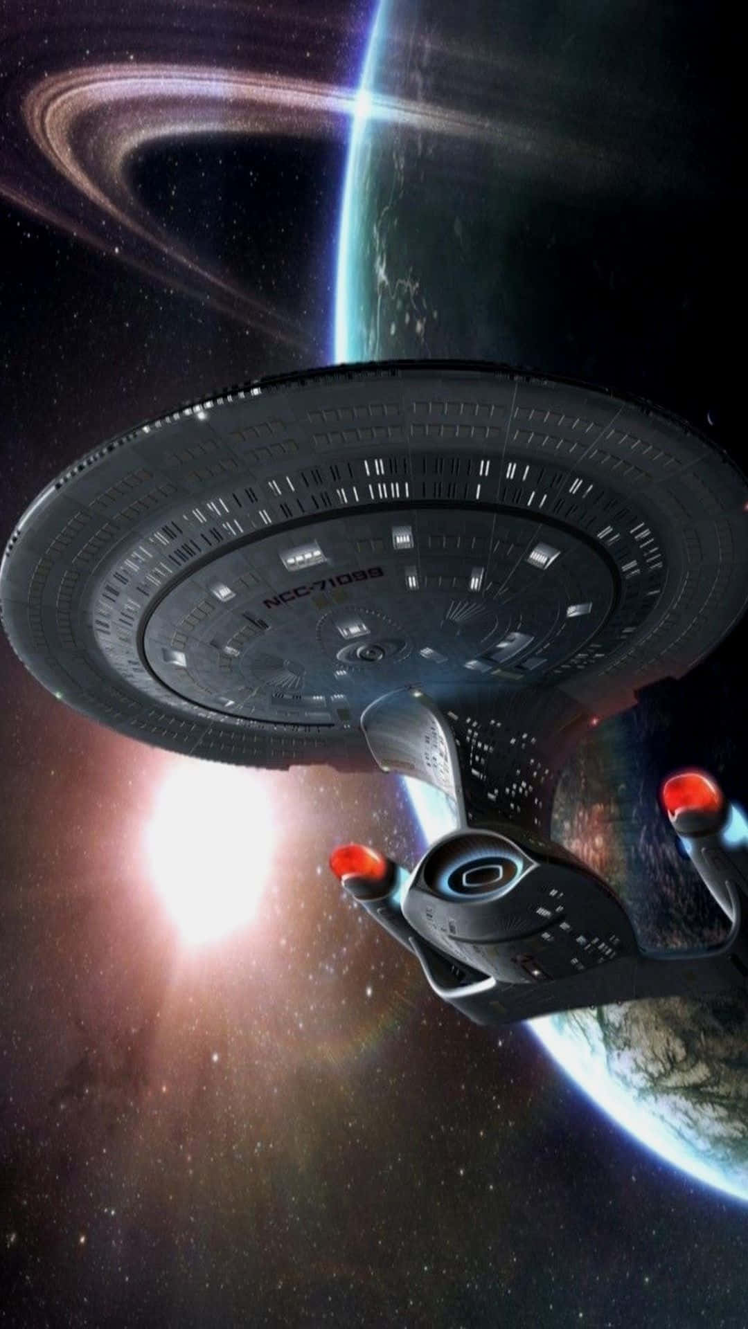 太空 桌布 壁紙 — 星艦企業號在深空中環繞一顆帶環行星運行，背後有一顆明亮的星星閃耀。