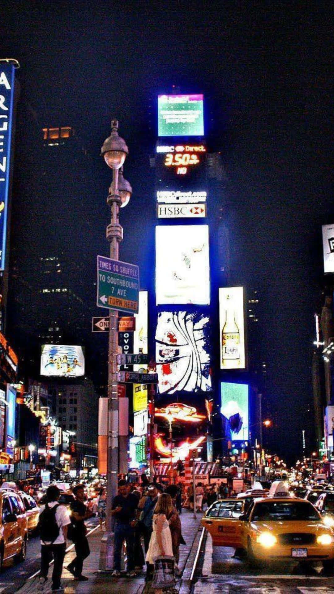 Android Ny City 桌布 壁紙 — 時代廣場充滿活力的夜間街景，霓虹燈下閃爍的廣告牌、計程車和行人。