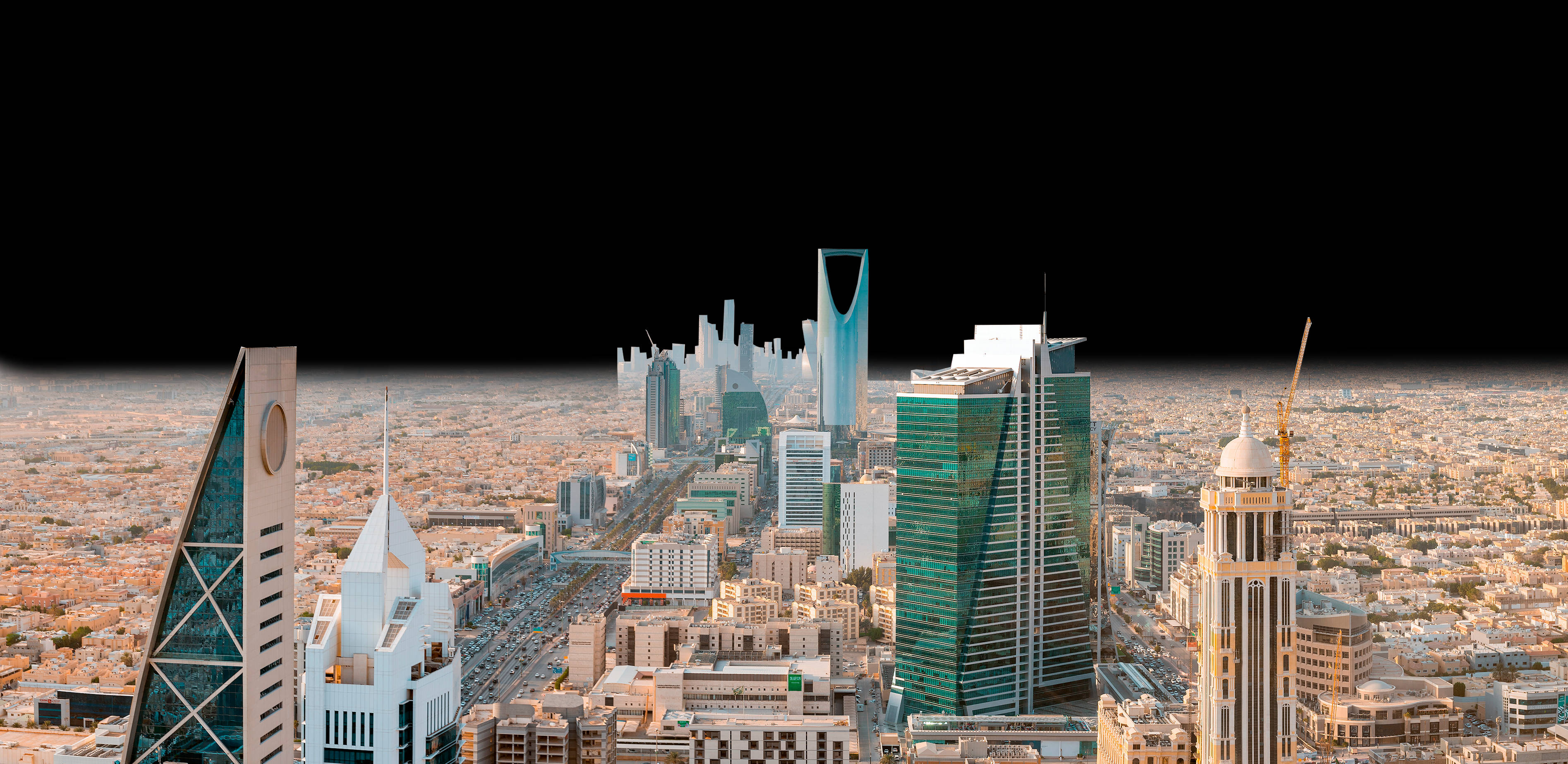 Riyadh 桌布 壁紙 — 晴朗天空下，現代城市景觀的鳥瞰圖，高聳的摩天大樓和密集的城市擴張。