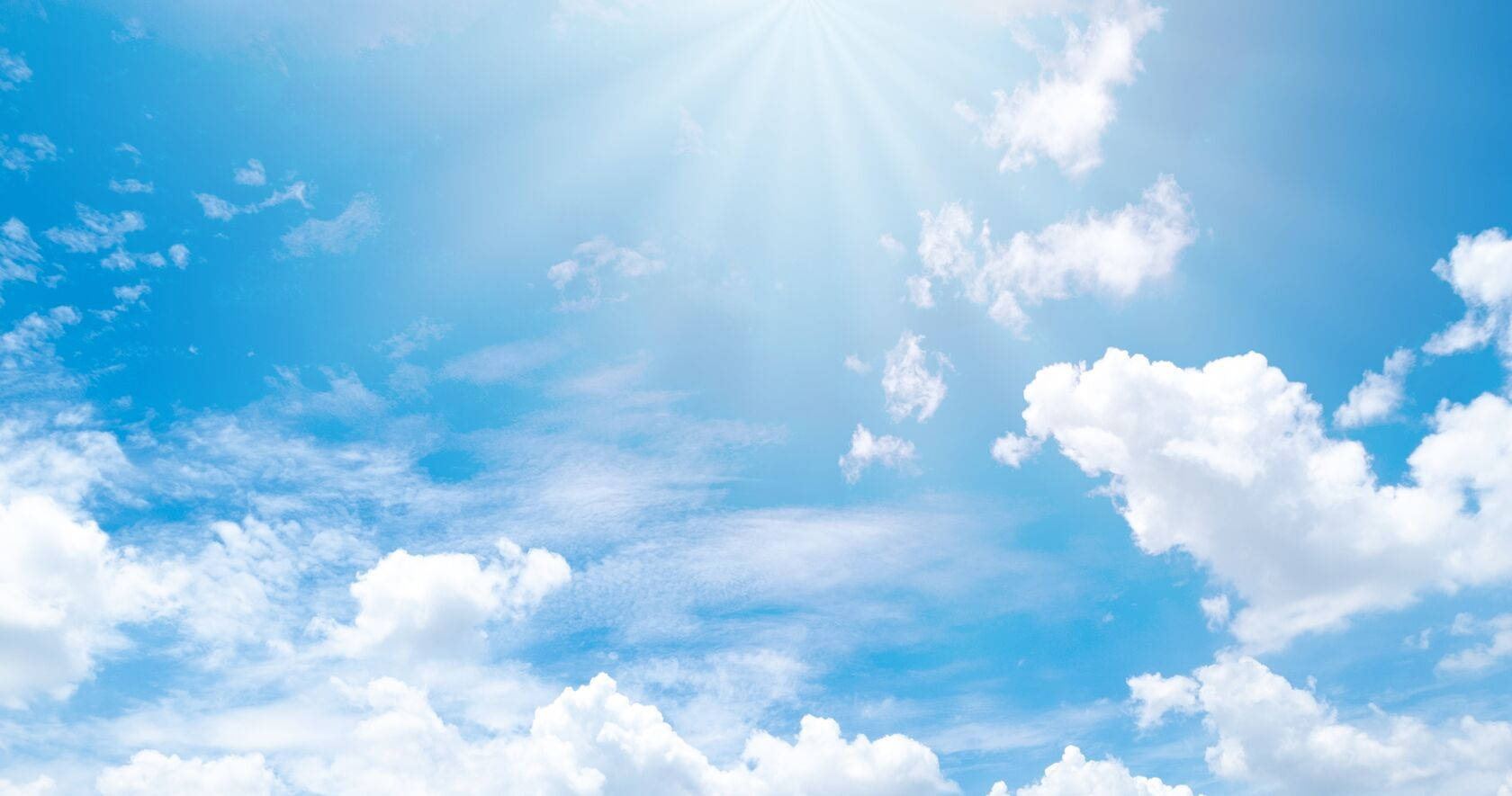 Blue Sky 桌布 壁紙 — 晴朗的日子裡，燦爛的陽光穿透蓬鬆的白雲，映襯著充滿活力的藍天。