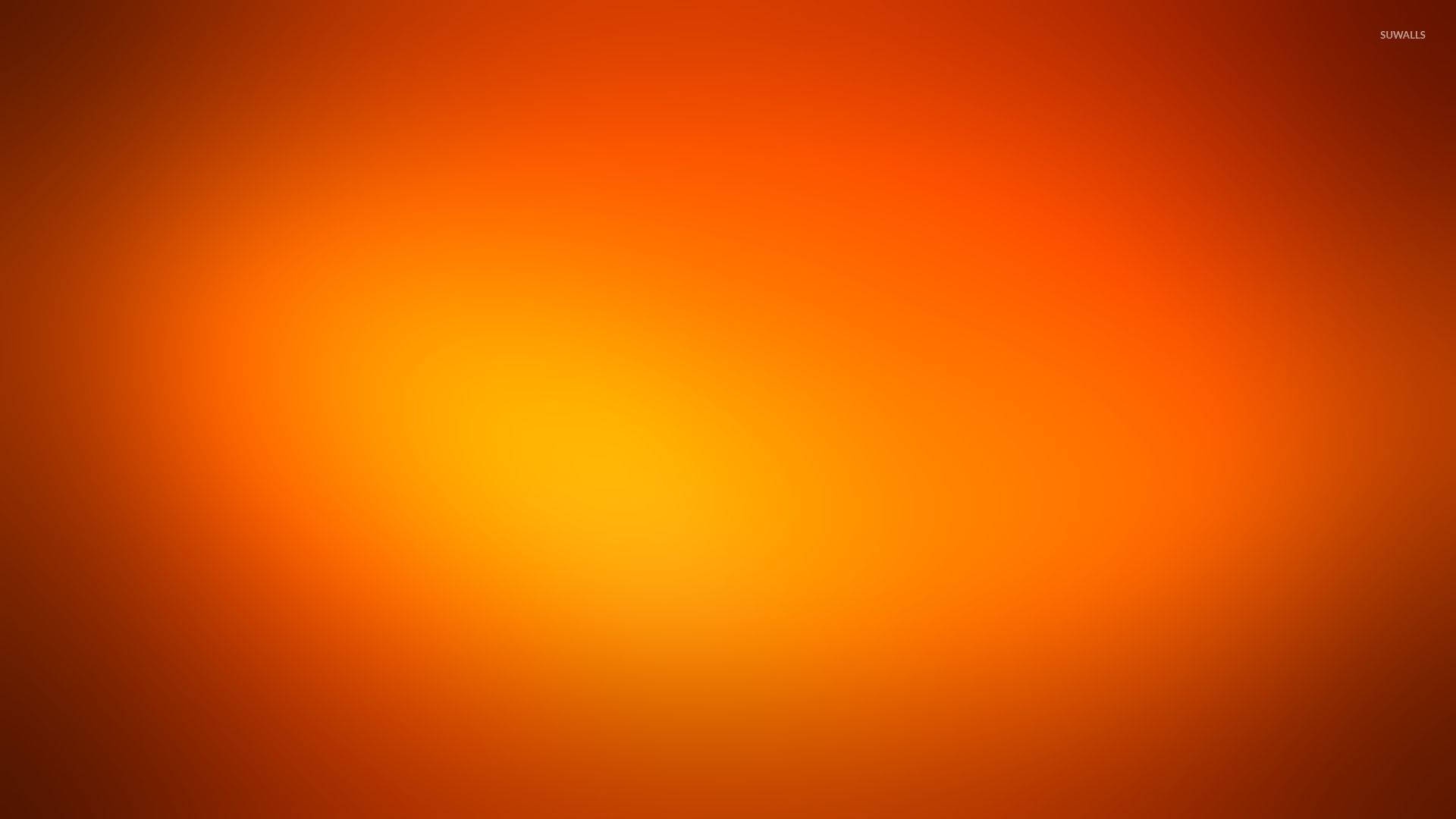 漸層 桌布 壁紙 — 暖橙色和黃色的平滑漸變從明亮的中心向外輻射，邊緣逐漸褪成深橙色。